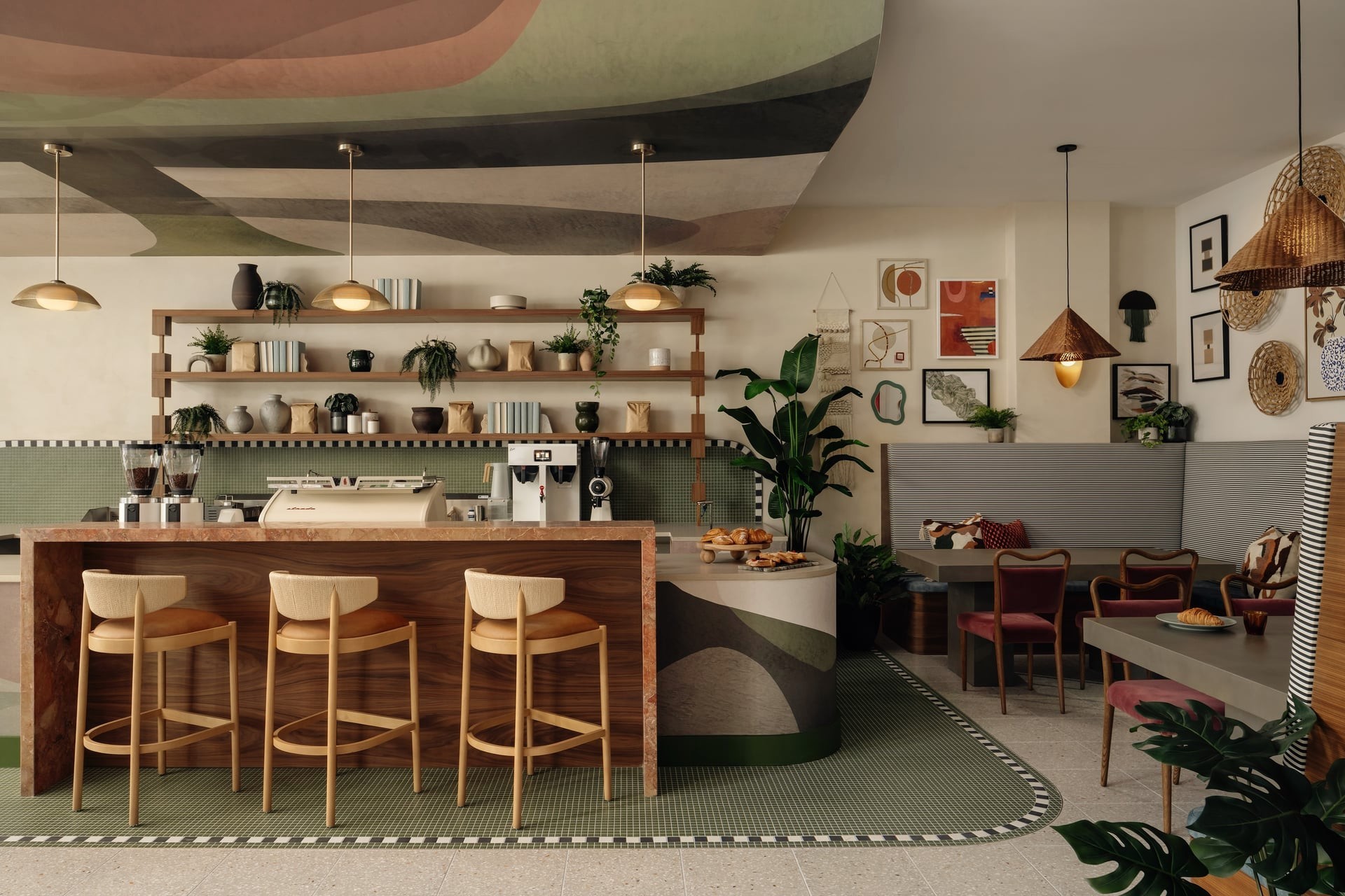 Contemporary coffee shop interior design with wooden service counter, brass pendant lights, green tile flooring, wall art display, and banquette seating.