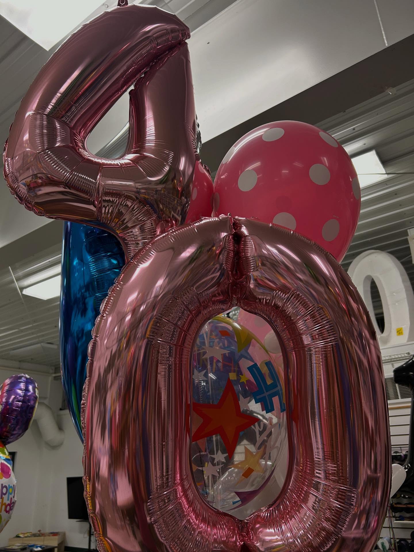 Metallic pink number 48 balloon centerpiece with coordinating balloon decorations crafted by Be Bold Balloons