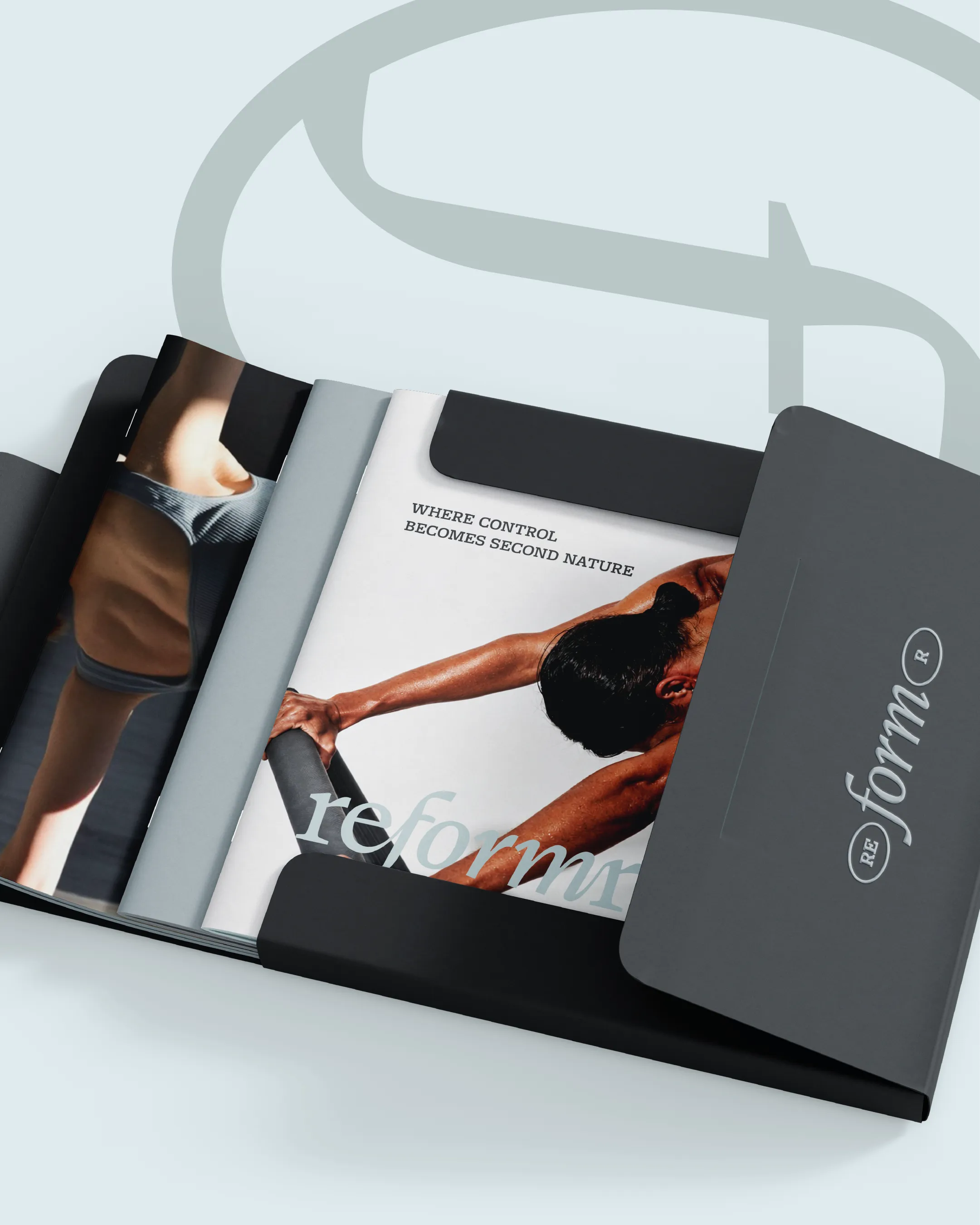 Reformr Pilates Studio brand identity — open folder with embossed logo on cover and 3 brand booklets inside