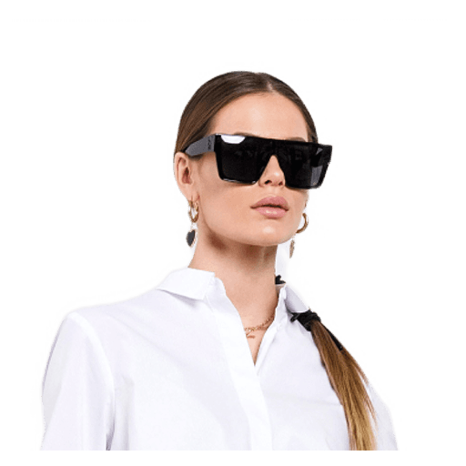 Woman wearing large black sunglasses and a white shirt, looking fashionable. 