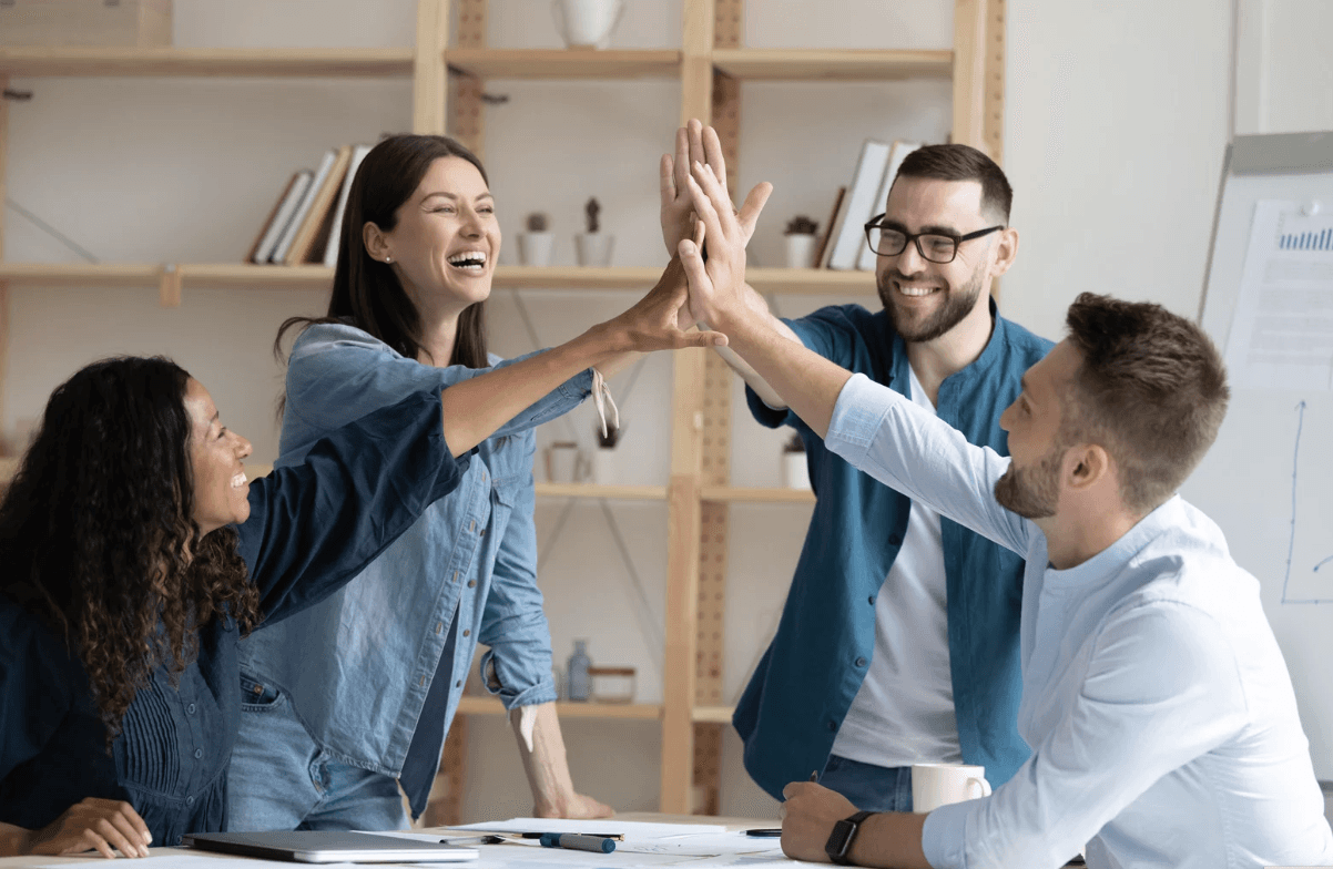 A group of young professionals working together, likely engaged in a team collaboration or discussion
