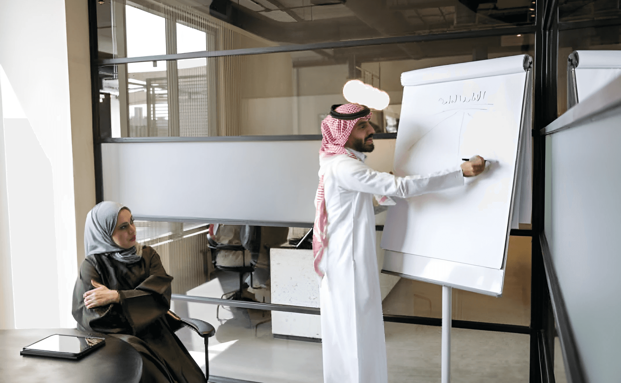 man drawing on dry-erase board