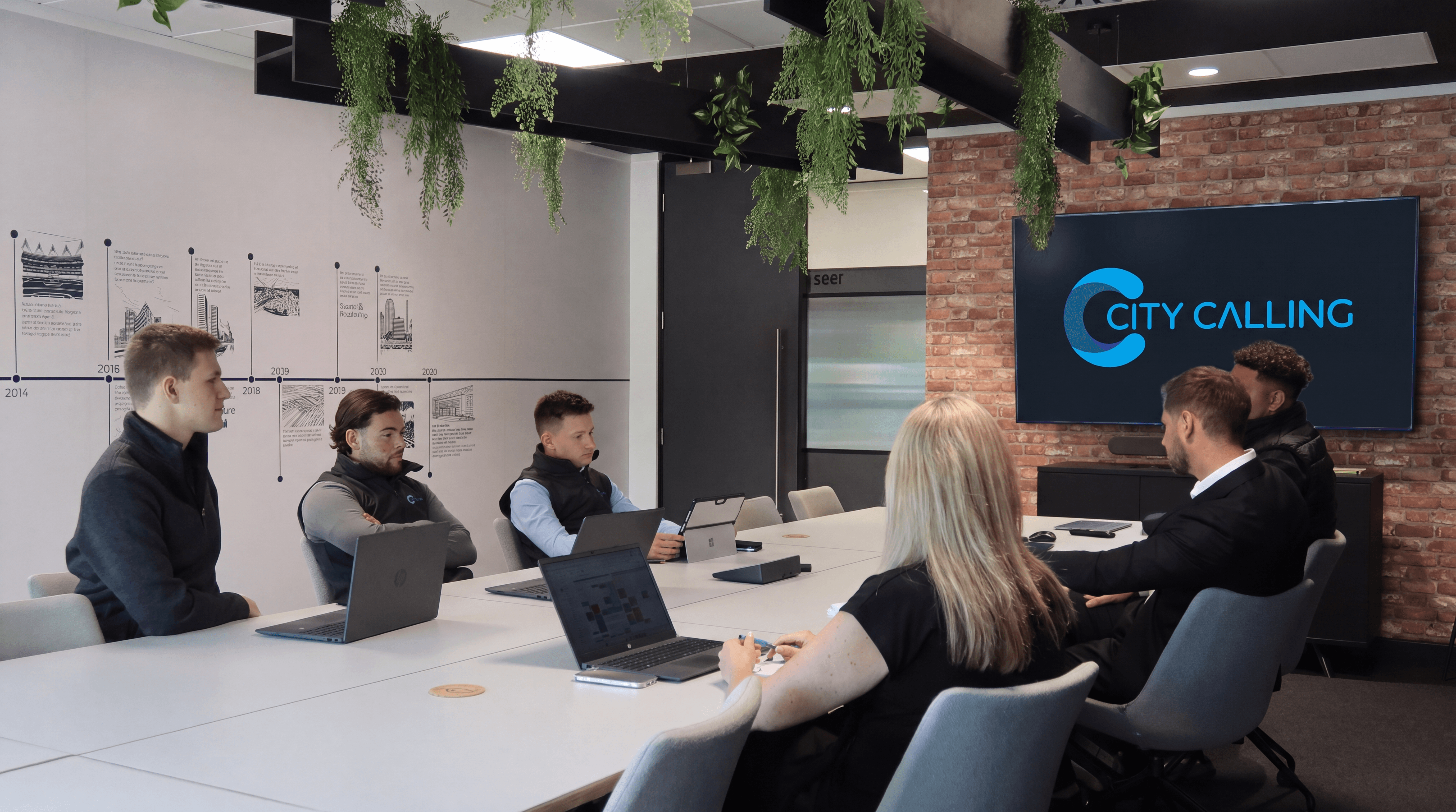 City Calling team in a meeting room with the company logo displayed on screen