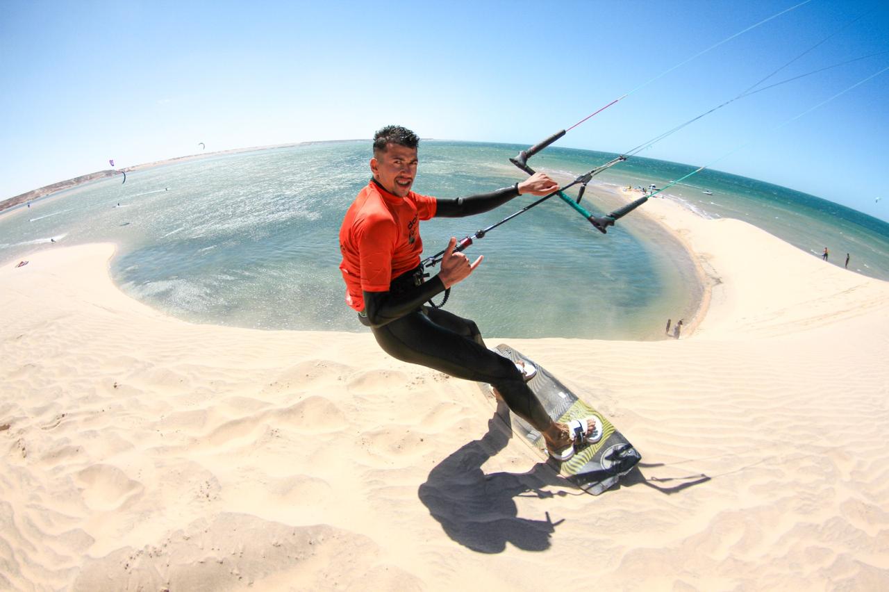 A man stading with Surfboard