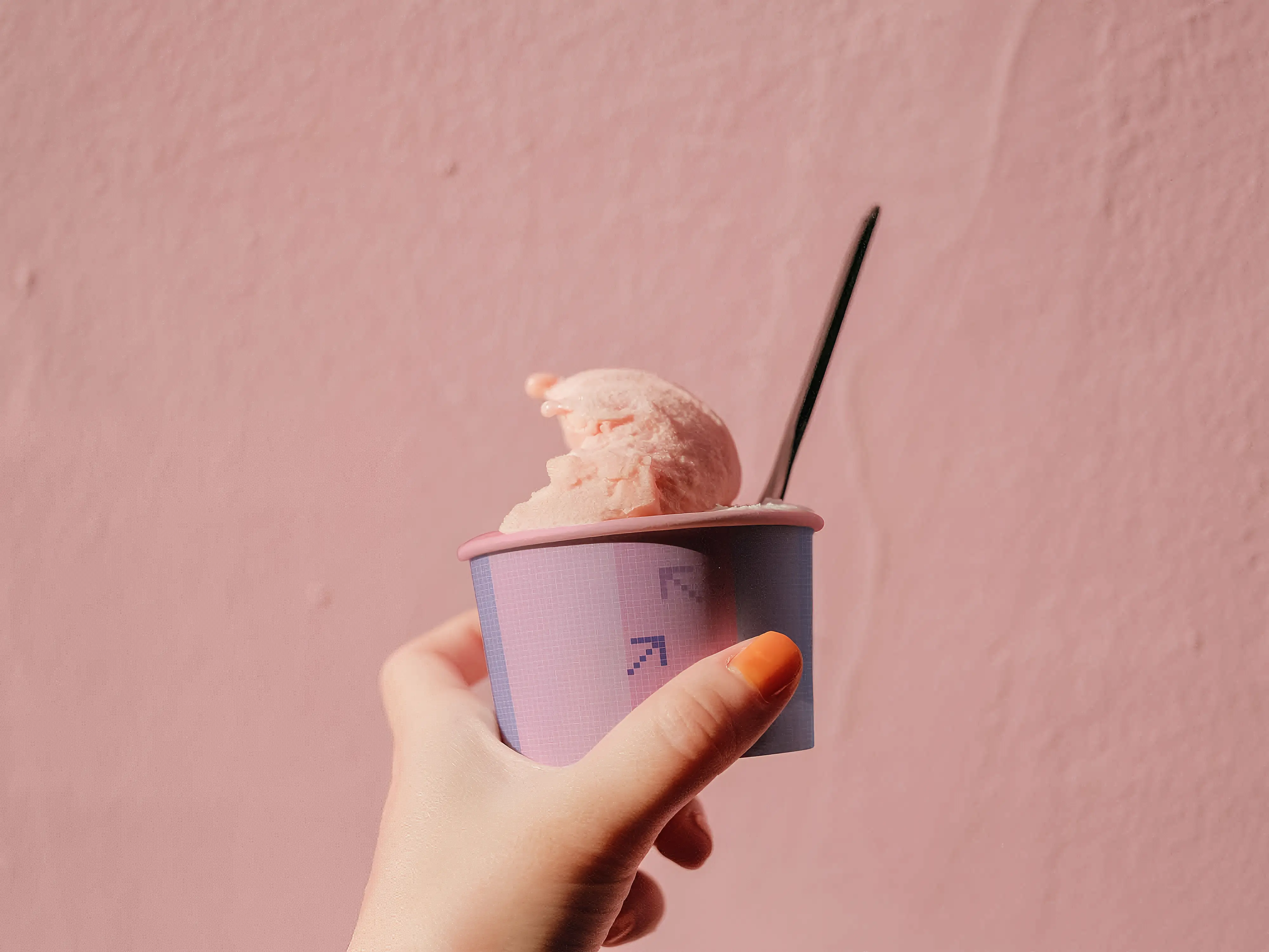 Hand holding ice cream cup