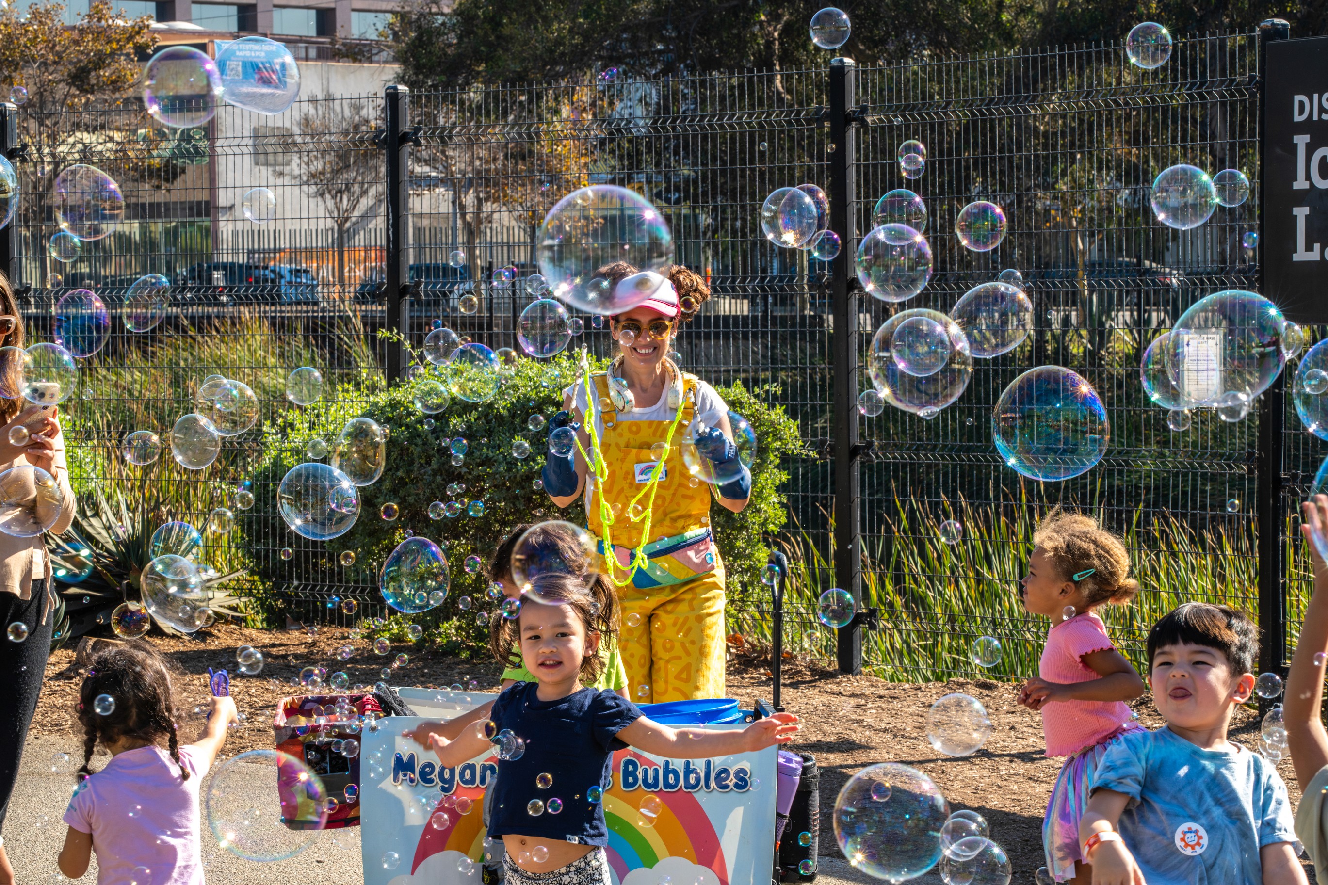 Logistics in action with event signage and organized queues at the large-scale public festival.