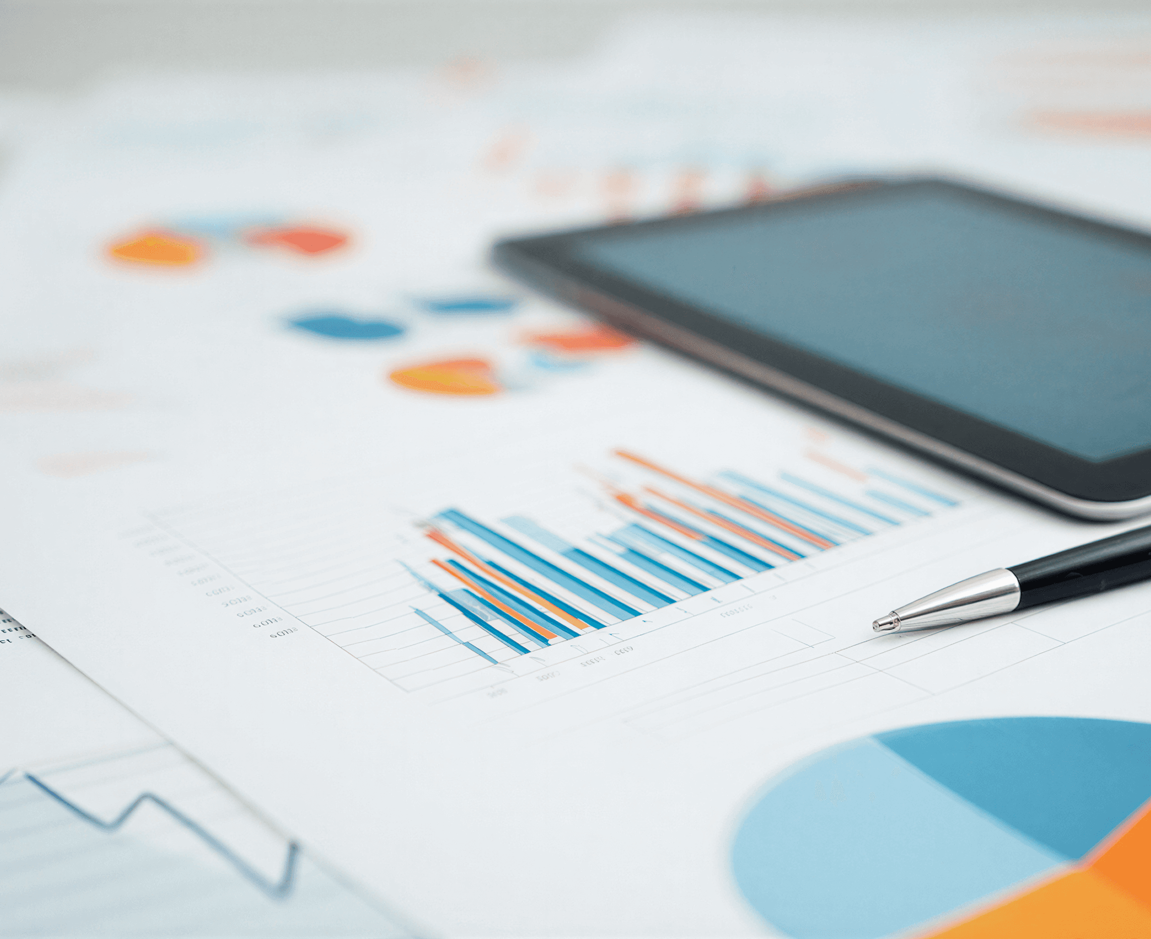 Business analytics and stock market graphs on office desk