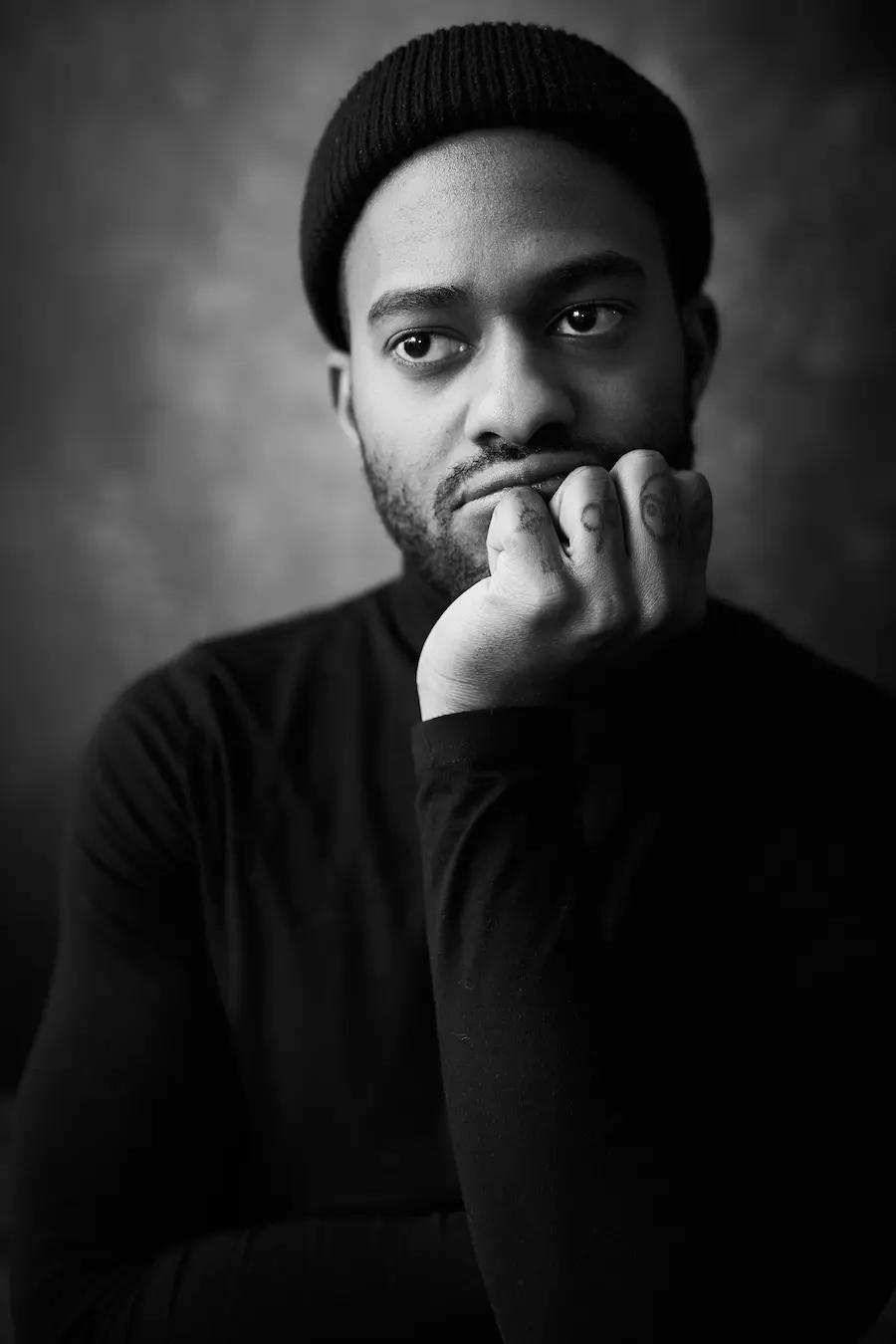 Black-and-white portrait of a Meridian Studio team member in a beanie, deep in thought