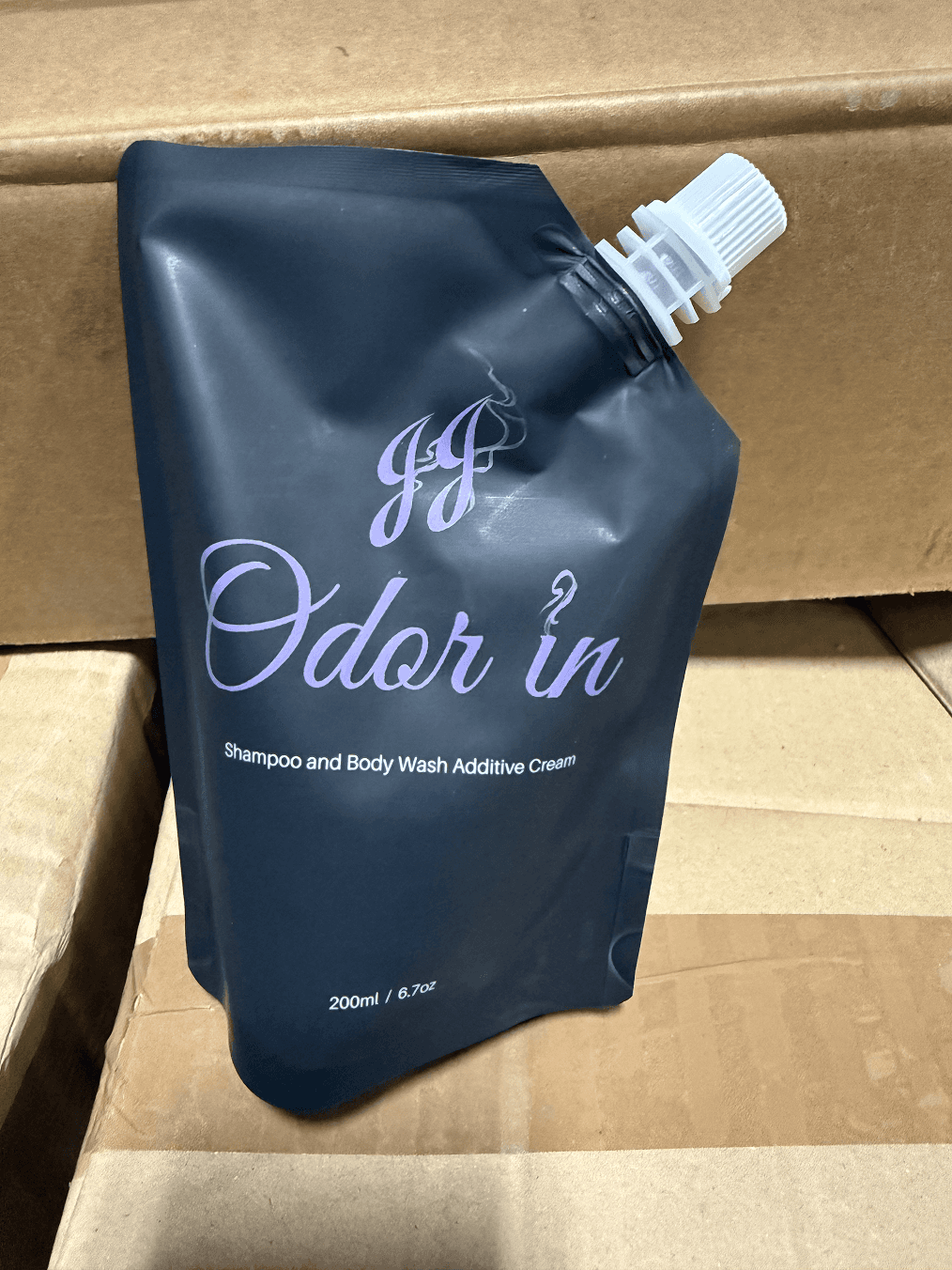 JJ Odor In shampoo and body wash additive cream in black pouch with spout.