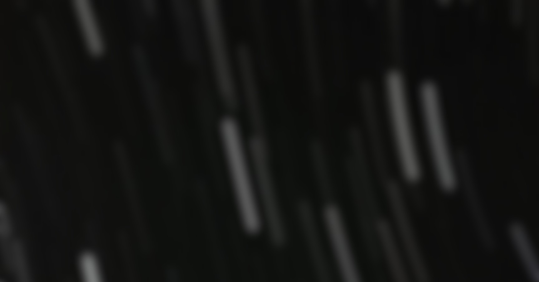 Slightly blurred image of a smart speaker with a glowing top, on a circular base.