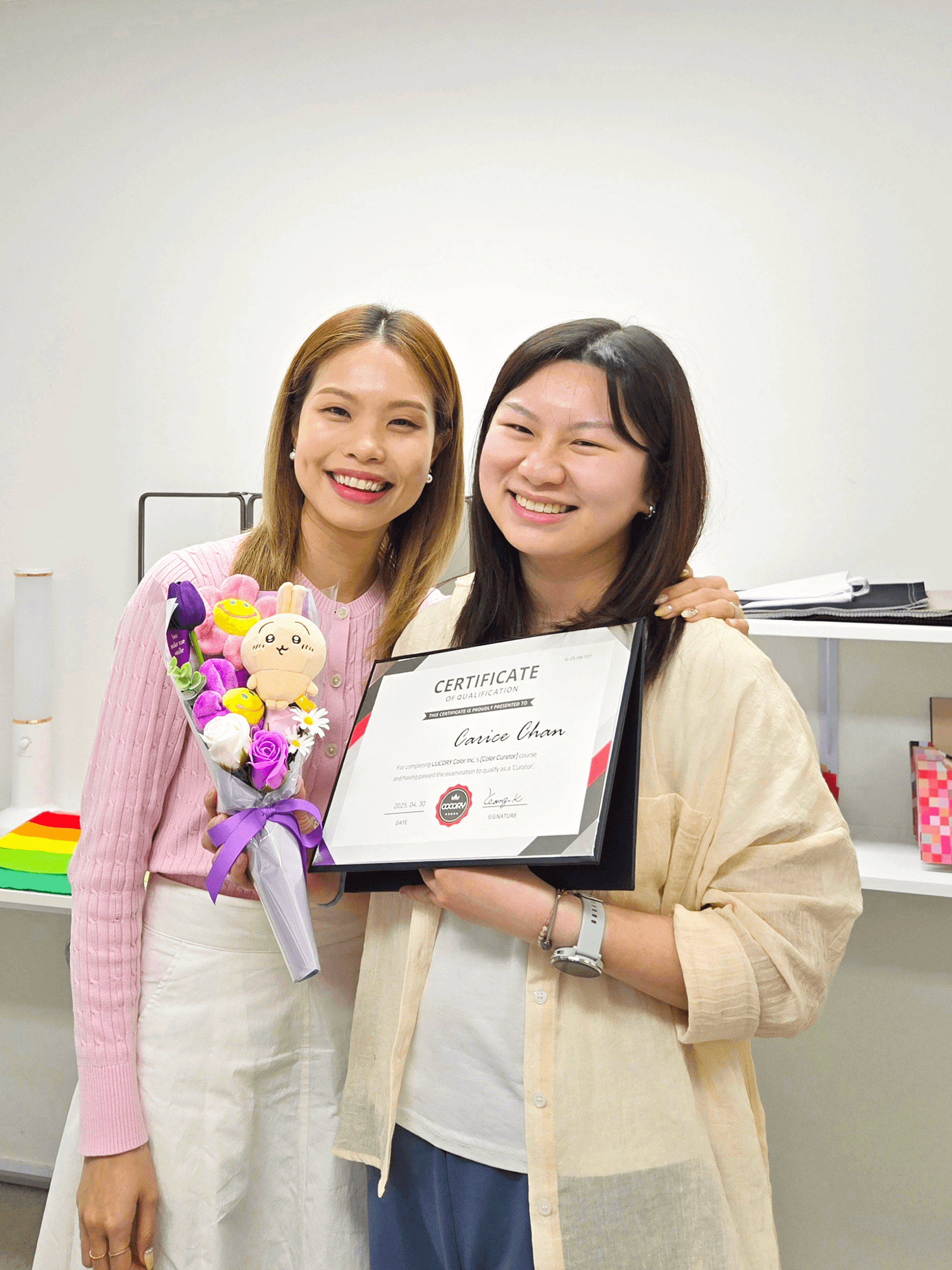 colour curator at her graduation with her instructor