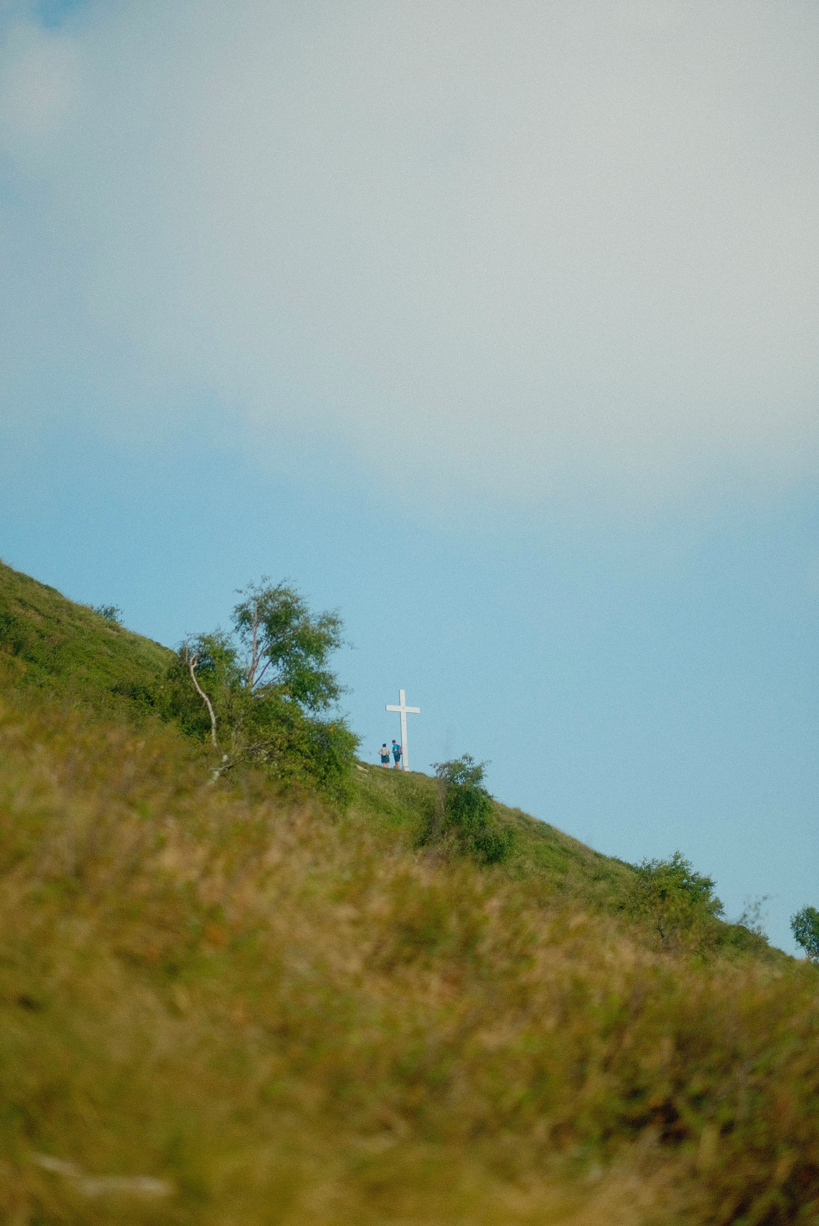 A hill with a cross on top of it
