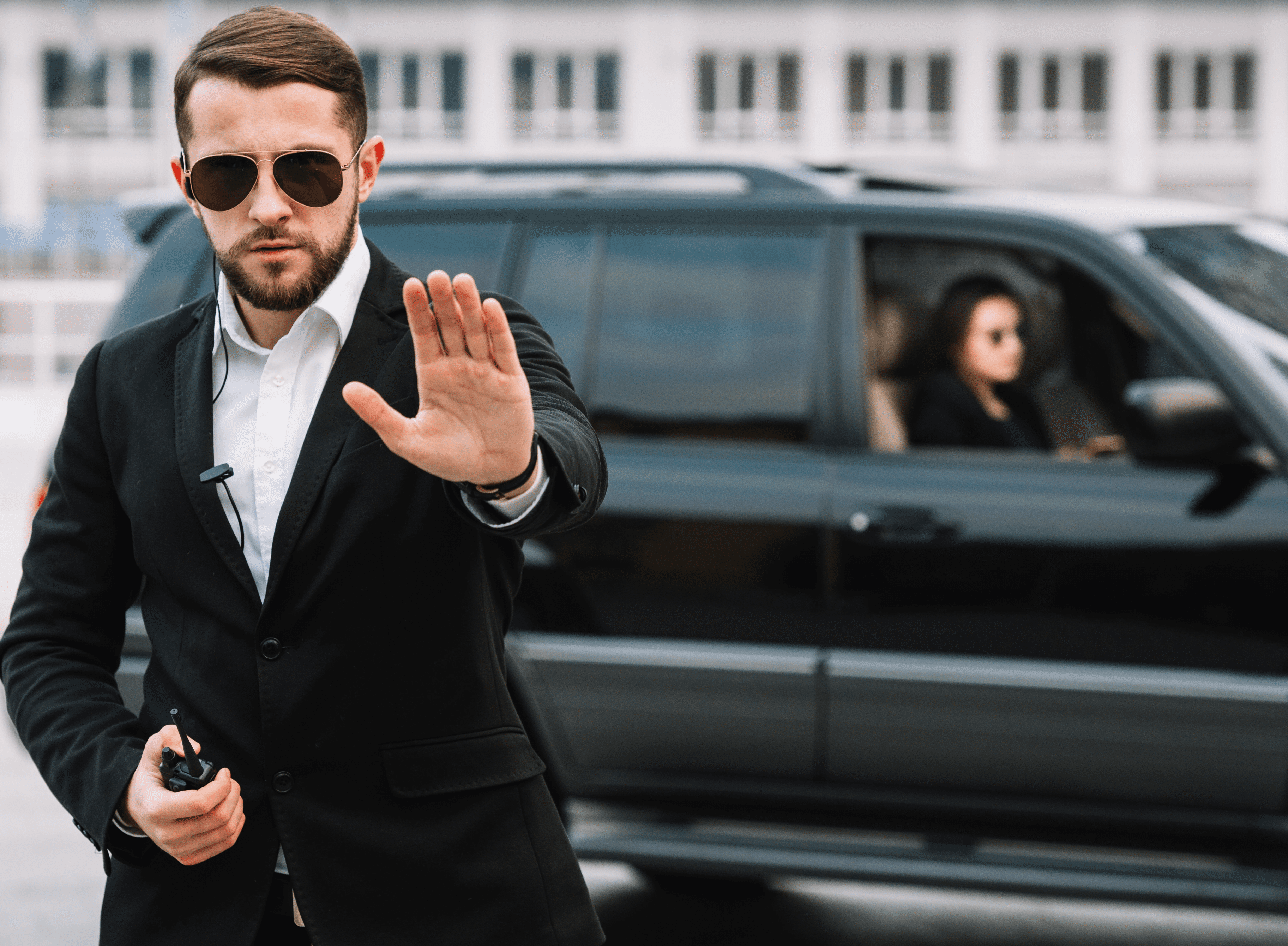 silhouette of man standing on seashore holding smoke can