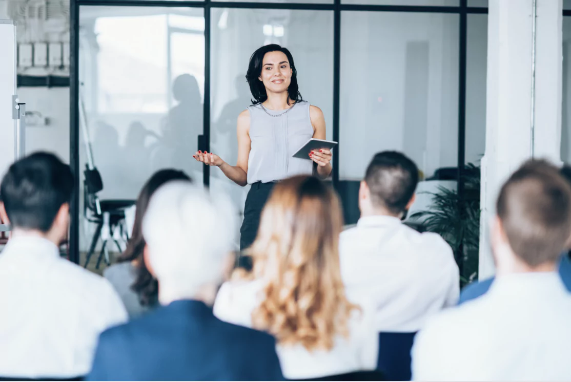 A lady giving a presentation to her colleagues in the office