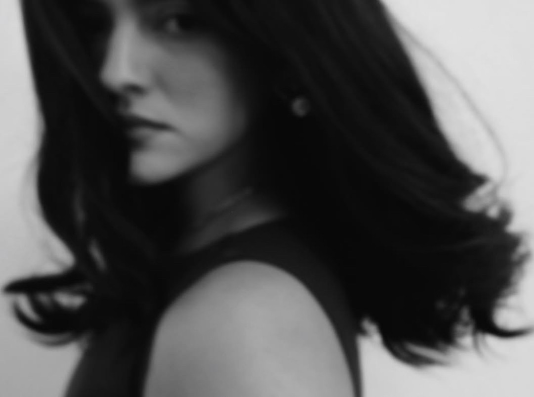 a blurry photo of a person standing in front of a wall