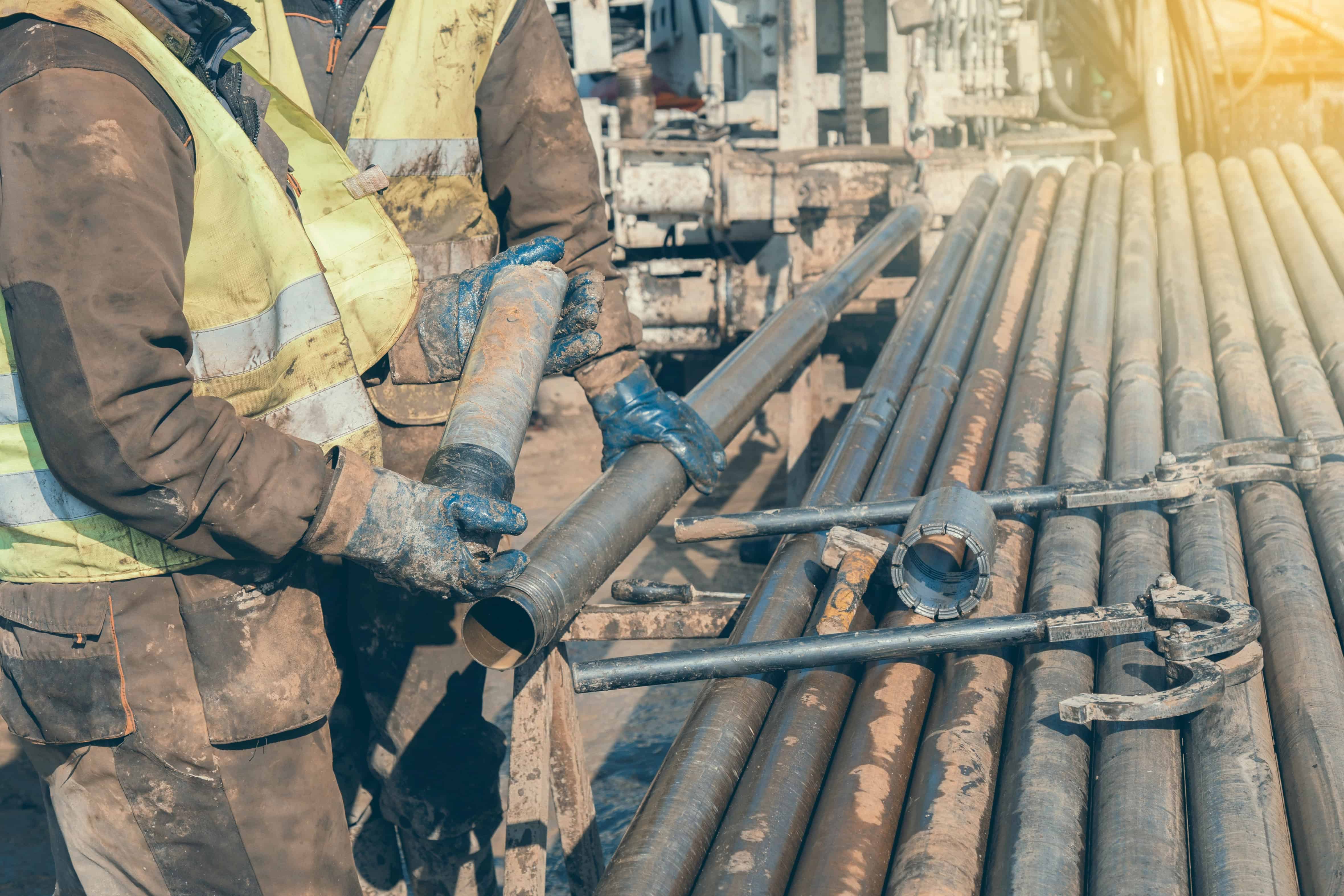 Diamond drilling crew extracting core at a mine site