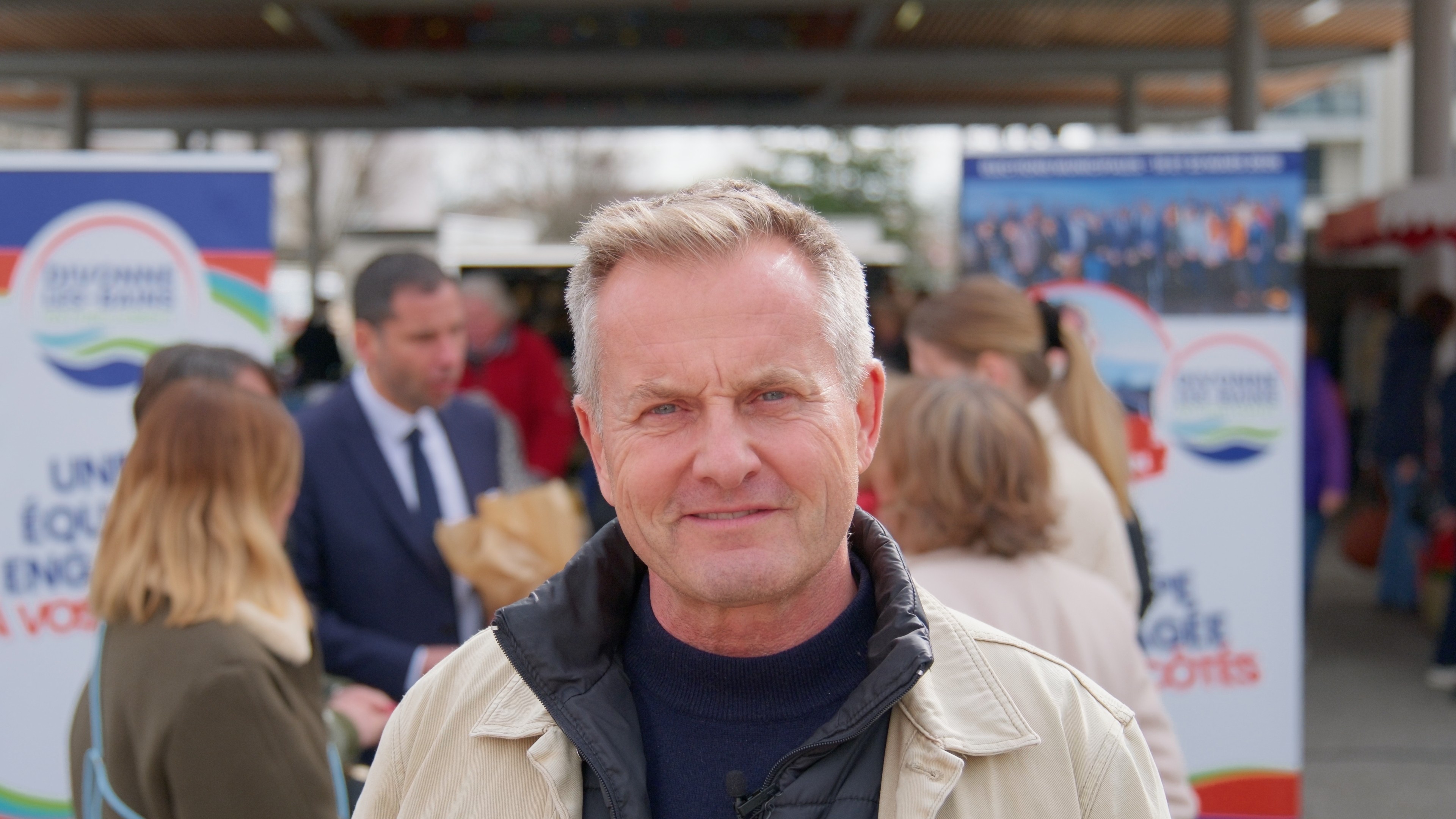 Sand dunes meet the ocean under a clear blue sky.