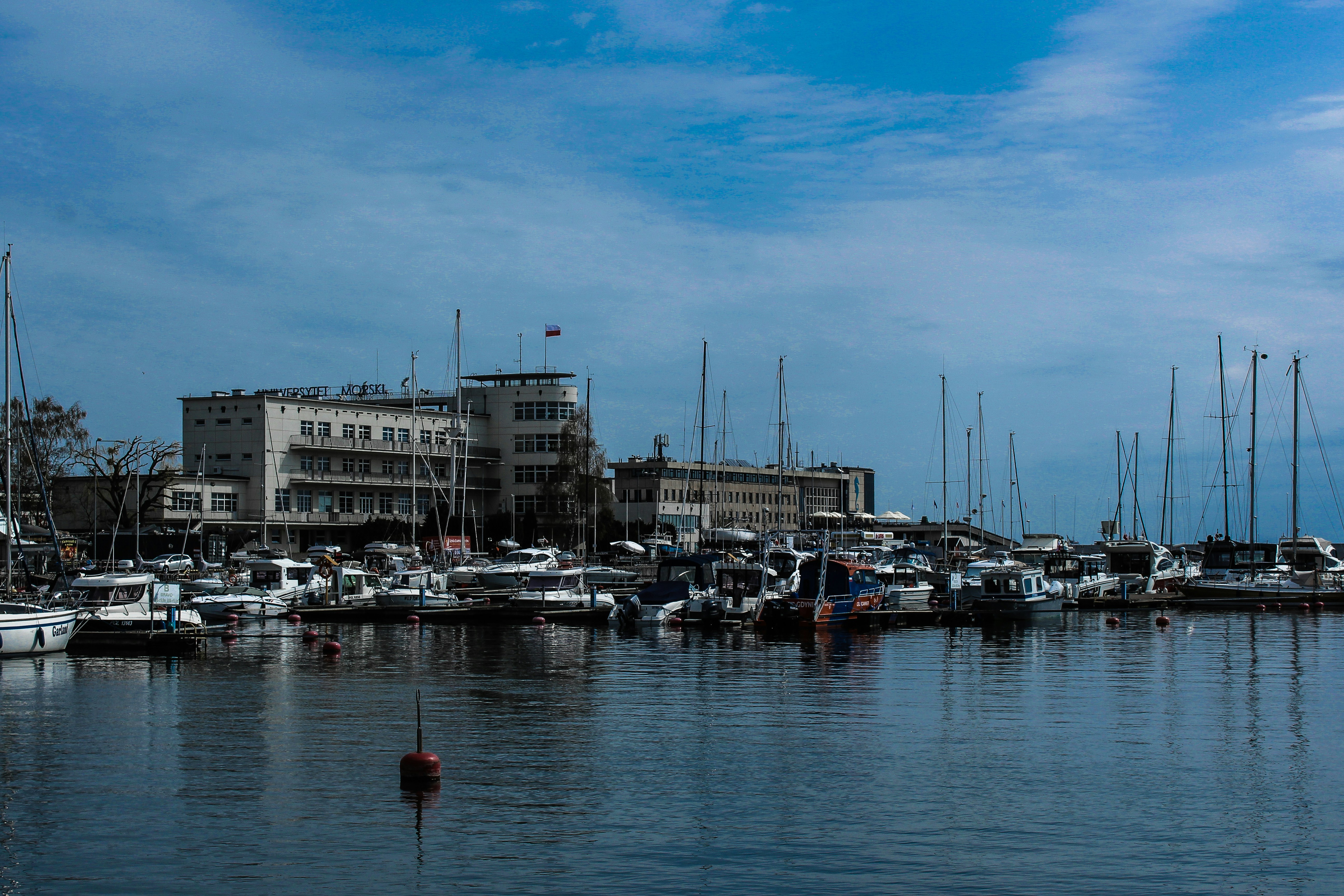 a harbor filled with lots of boats under a blue sky