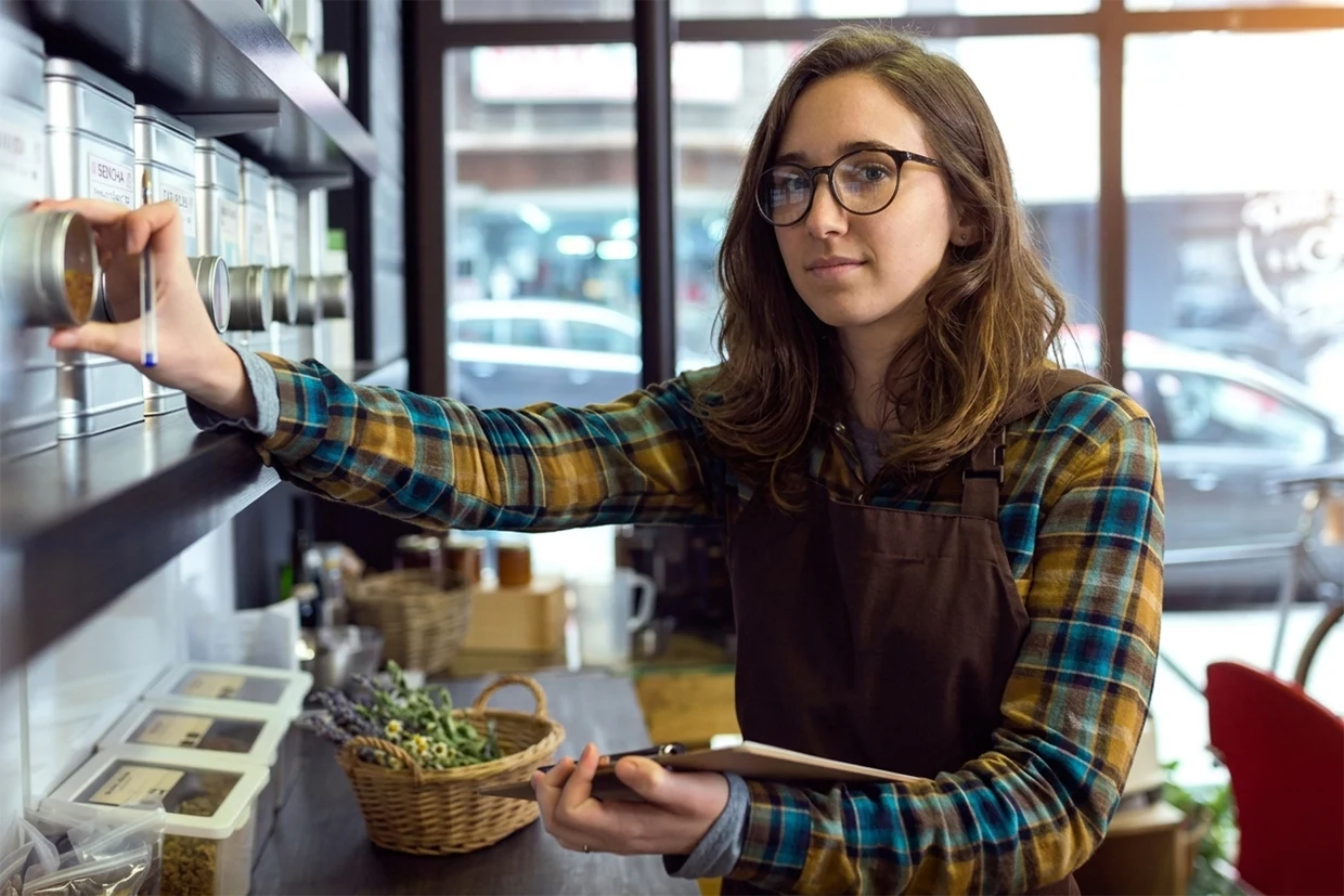 A woman who works at a tea shop, carrying out an inventory audit.