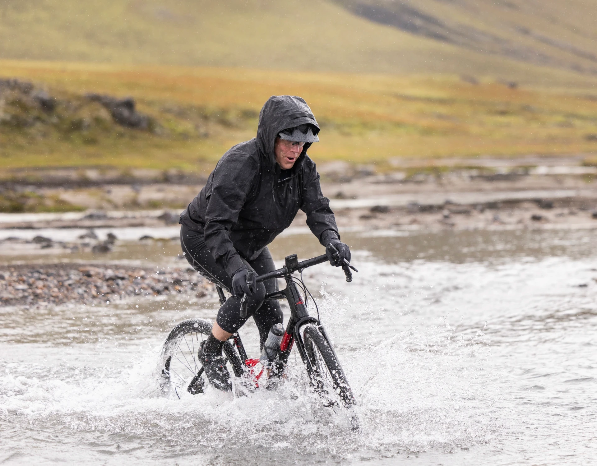 man crosses river on a bike
