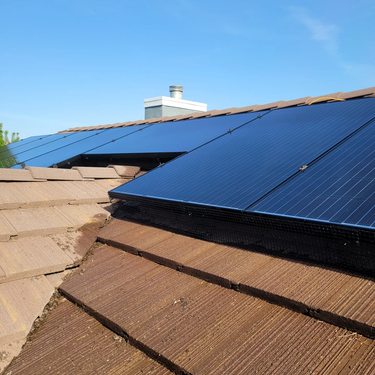 Clean dark solar panels on a tile roof, close angle | Premier Solar Service