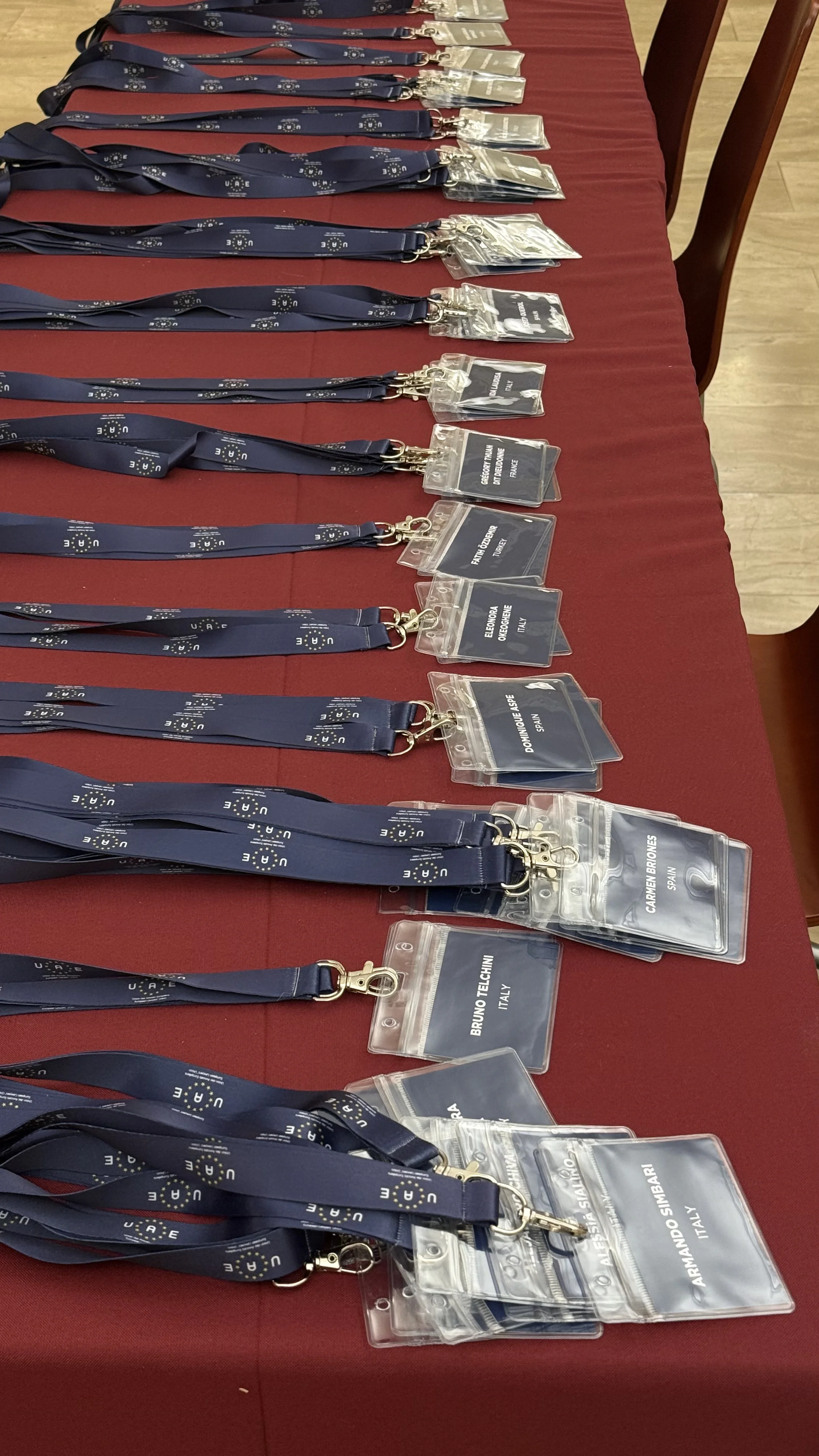 Lanyards laid out on a red table