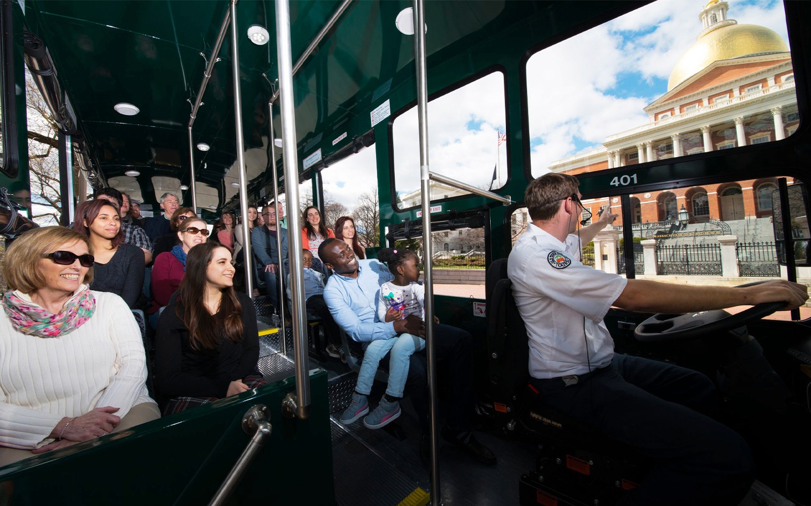 Passengers inside Old Town Trolley Bus in Boston, viewing the Massachusetts State House.