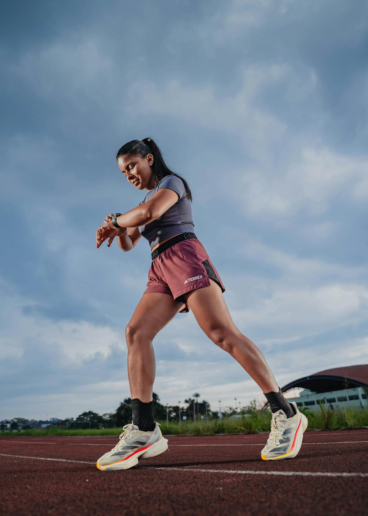 Woman running looking at her watch