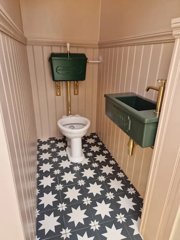 Contemporary ensuite bathroom renovation featuring a double basin vanity unit, matte black fixtures, and a walk-in shower with dark herringbone tiles-the wall nuts project work