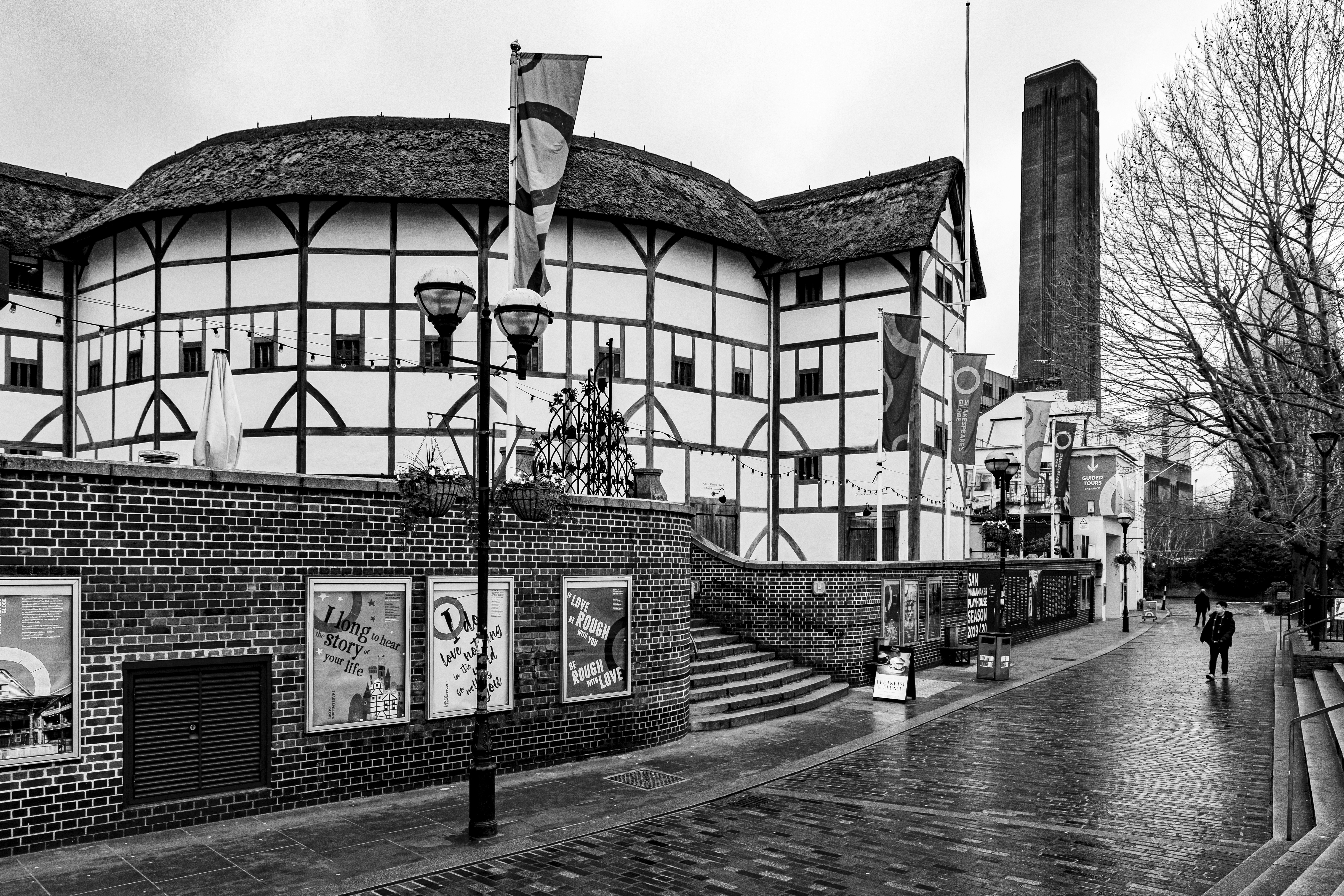 grayscale photo of the exterior of Shakespeare's Globe Theatre in London