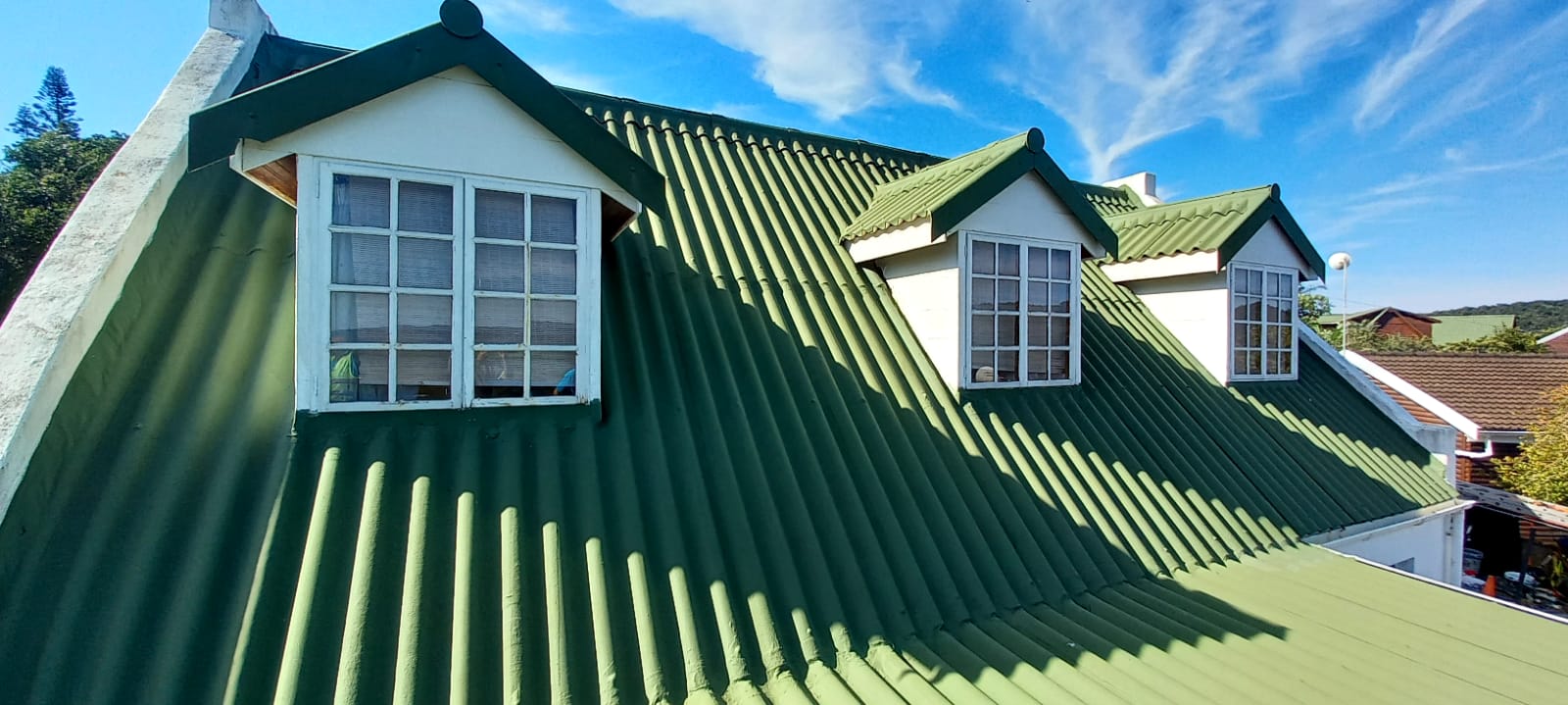 House roof getting sprayed with waterproofiing rubber