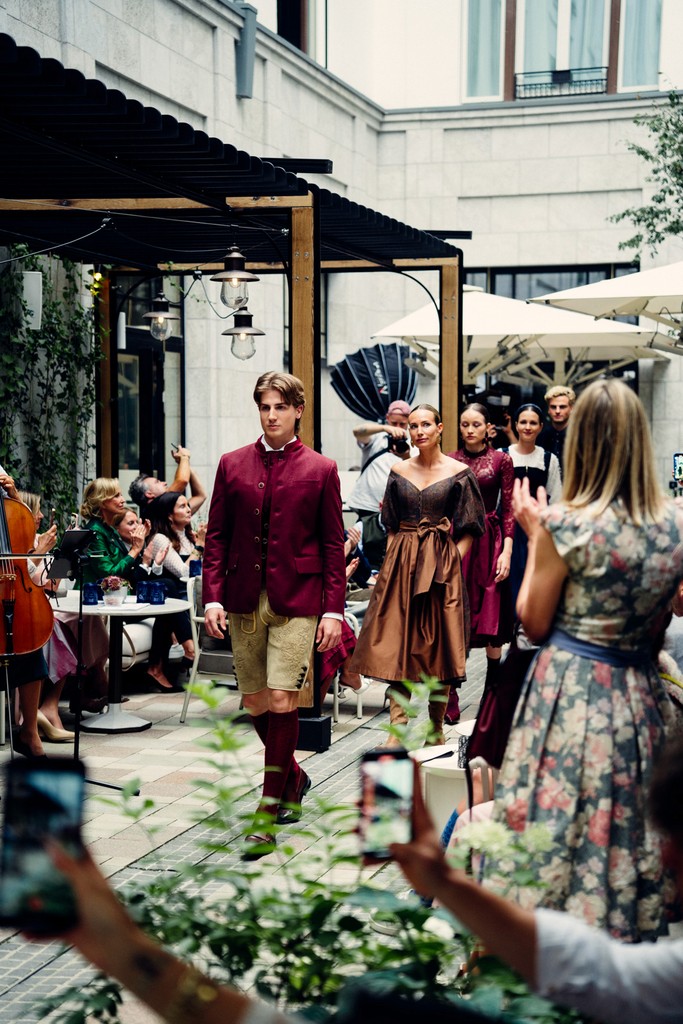 Models dressed in traditional Bavarian attire posing at an event