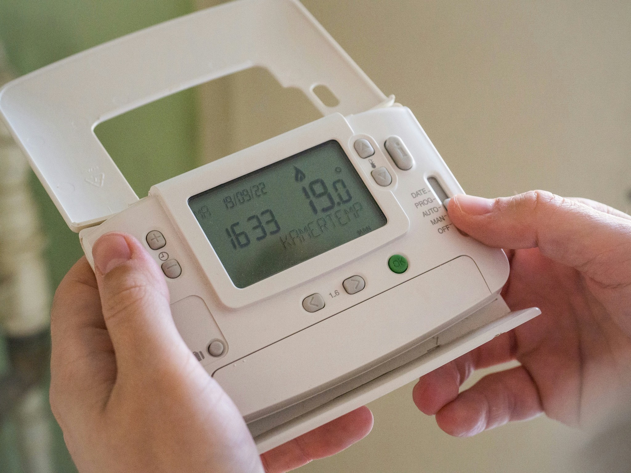 A heating control panel with temperature settings and adjustment buttons.