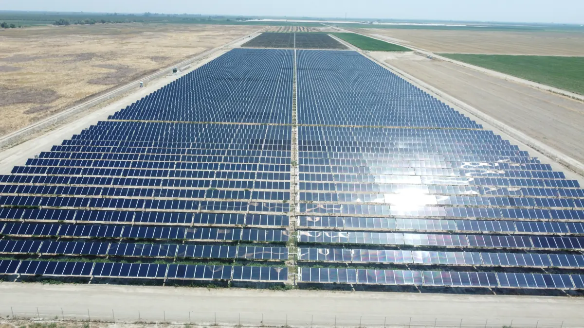 Drone view of long ground-mount solar rows at Madera Winery in Madera, CA