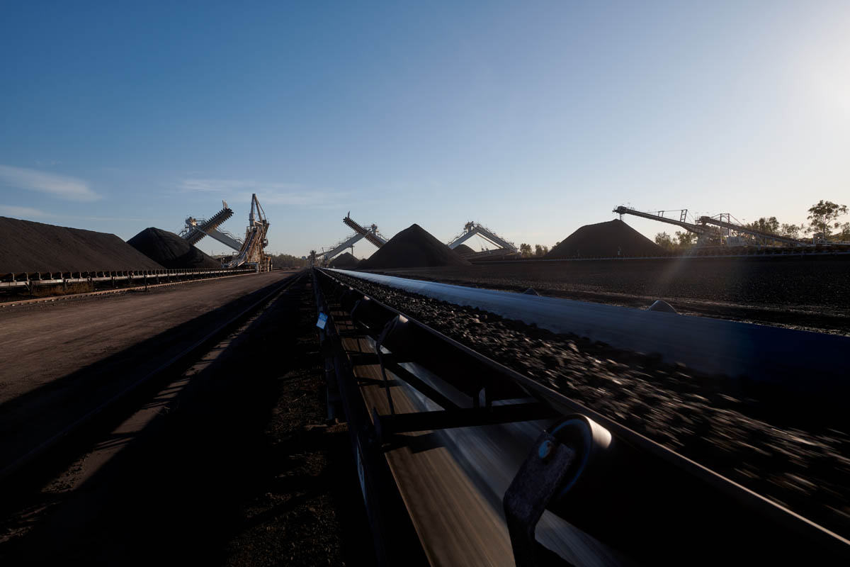 Mine conveyor and coal stockpile infrastructure at dusk