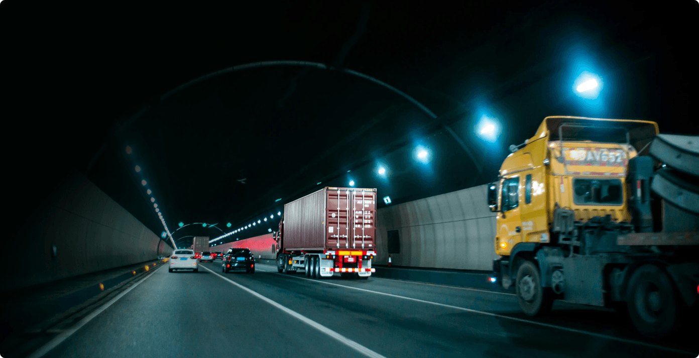 trailer truck passing on road near rail guard