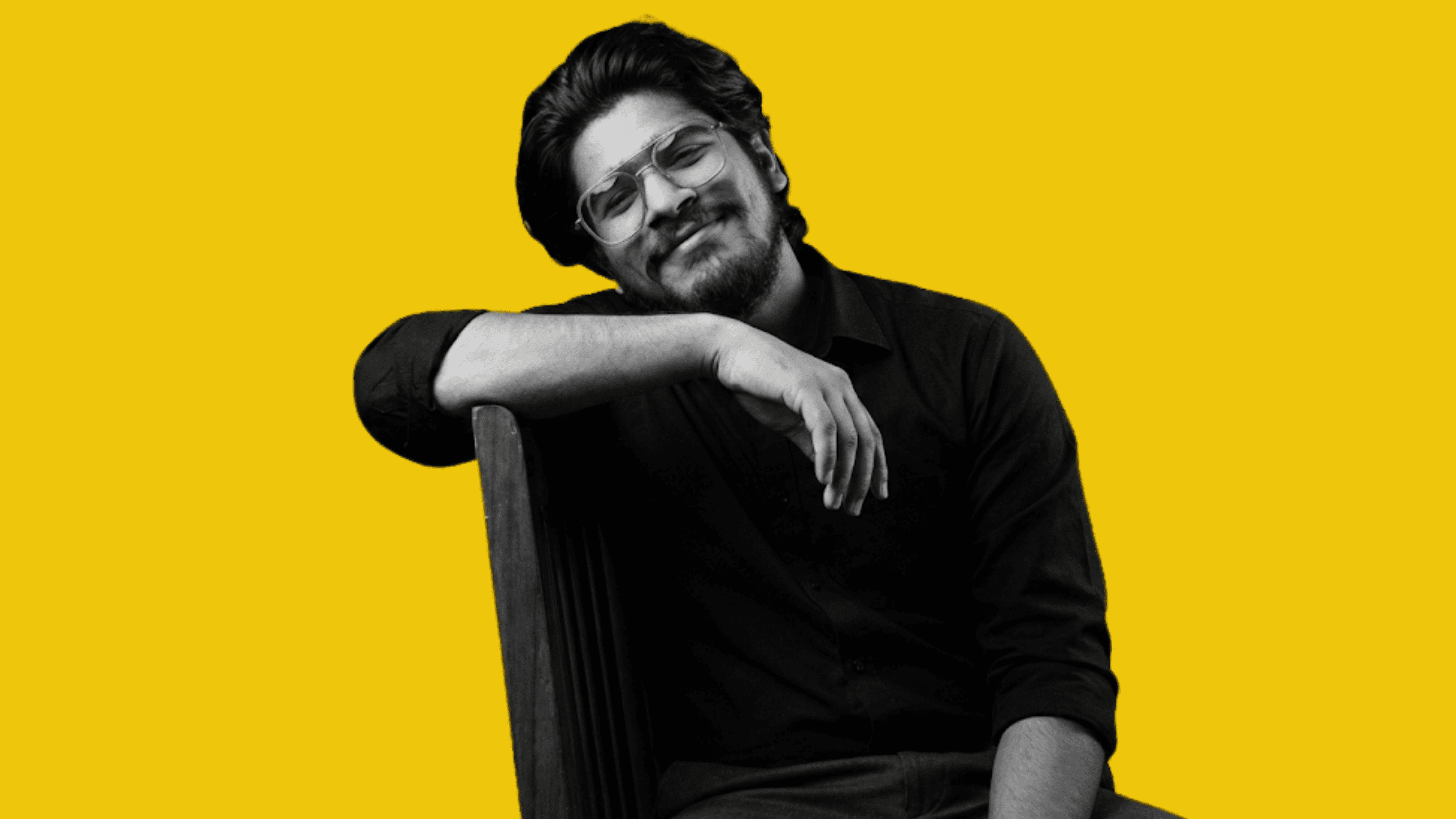 A young boy in formal attire looks forward.