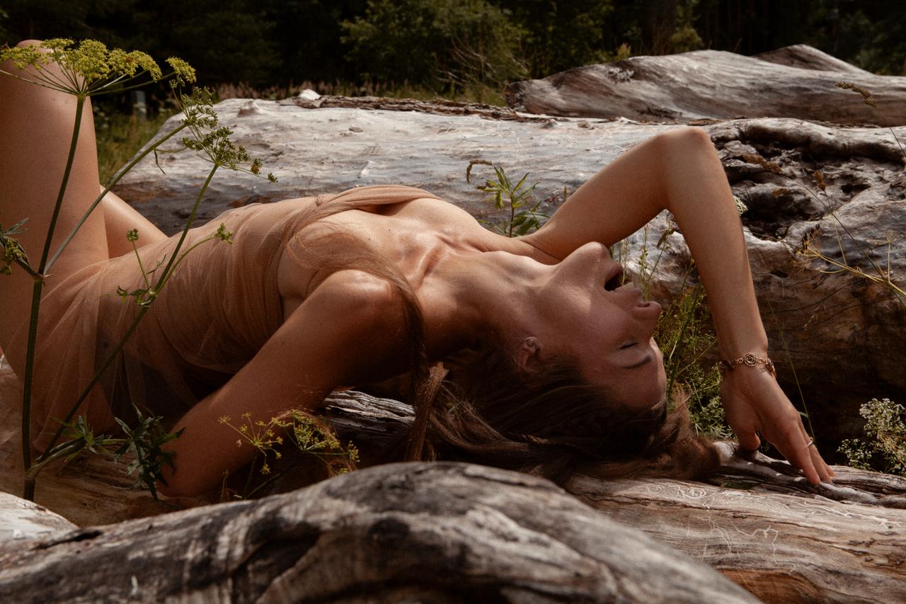 woman laying on a fallen wood trunk