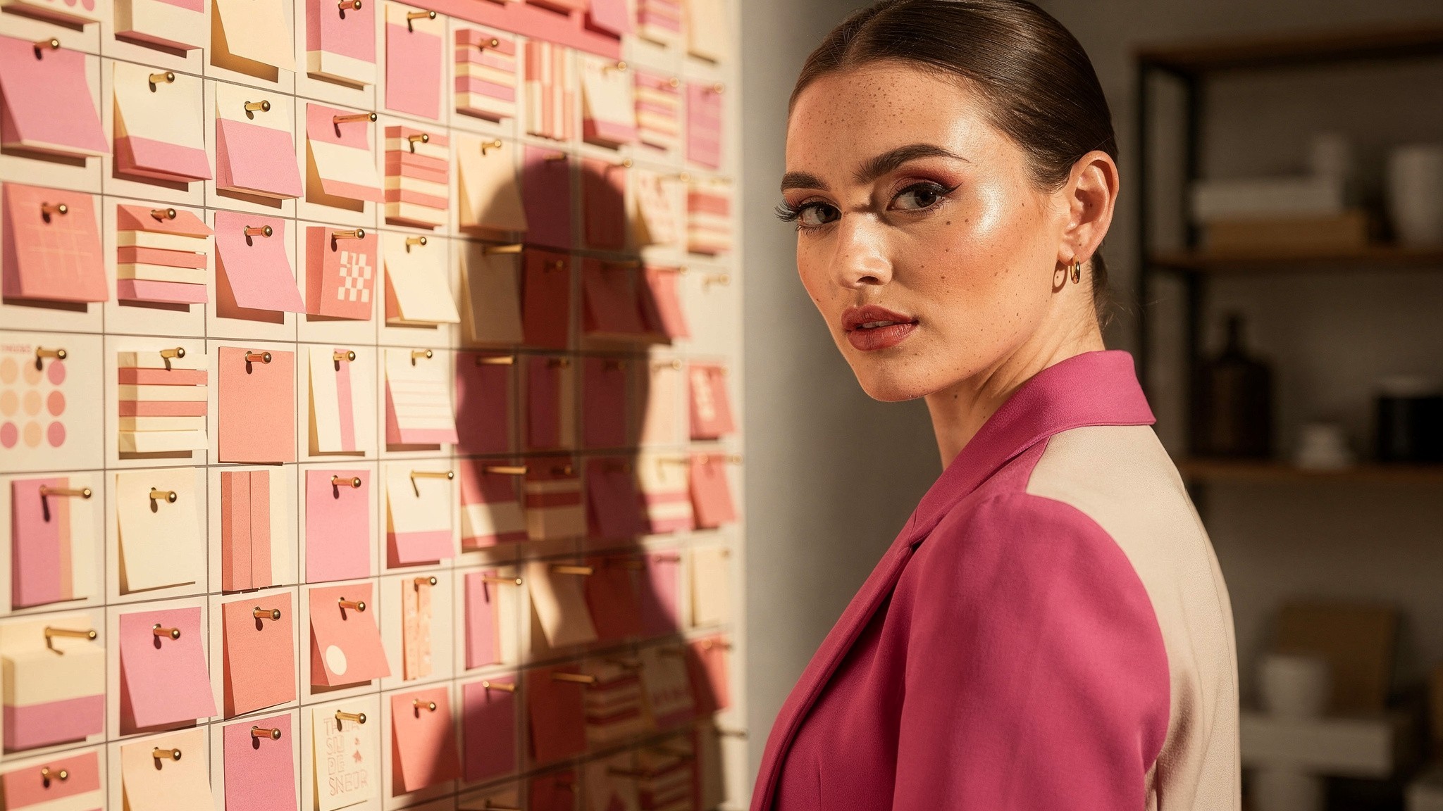 Creator reviewing a wall planner pinned with content ideas