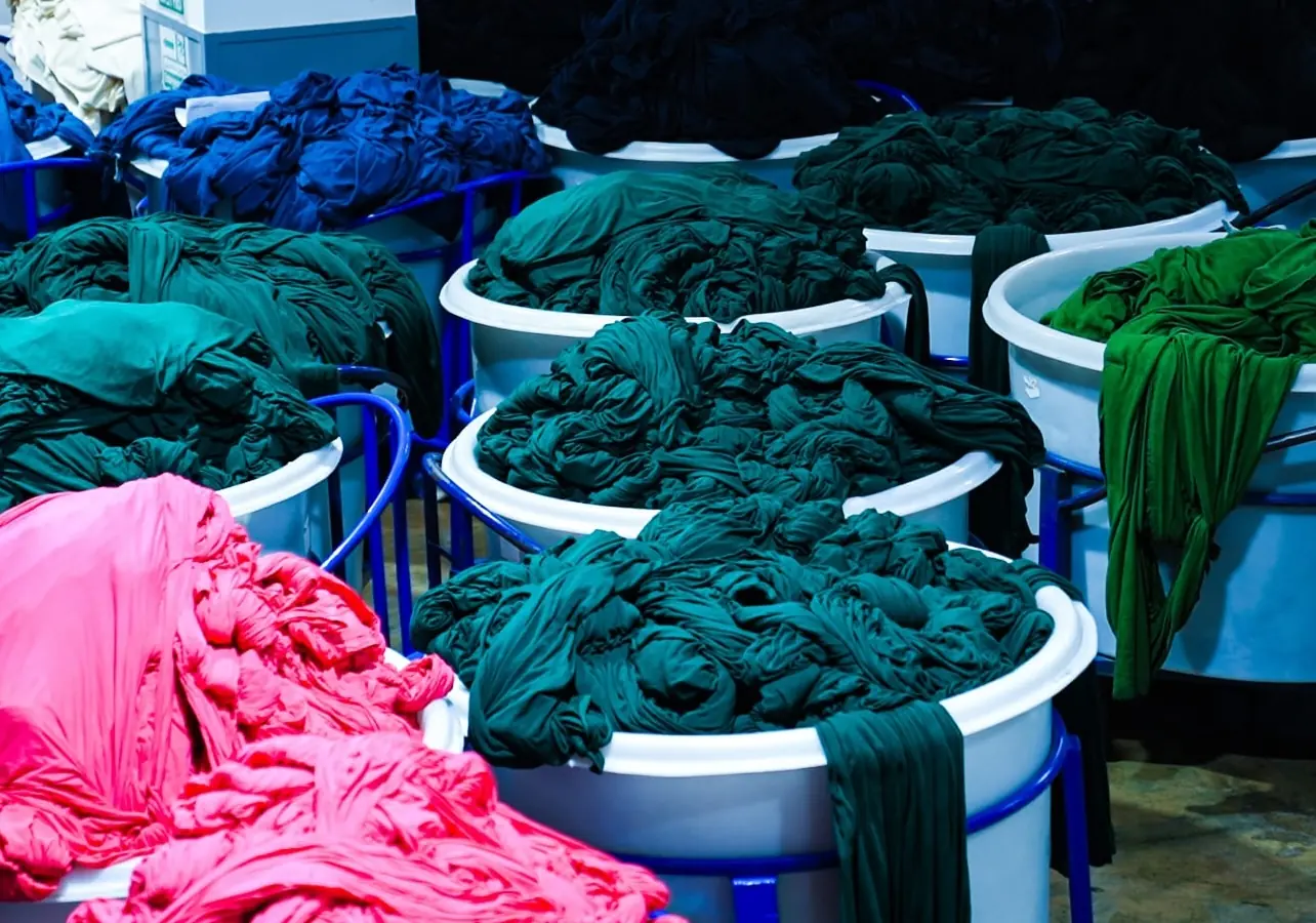 Fabric bundles in dye tubs.