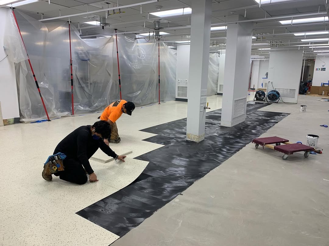 Conductive underlayment rolled out ahead of static-dissipative tile