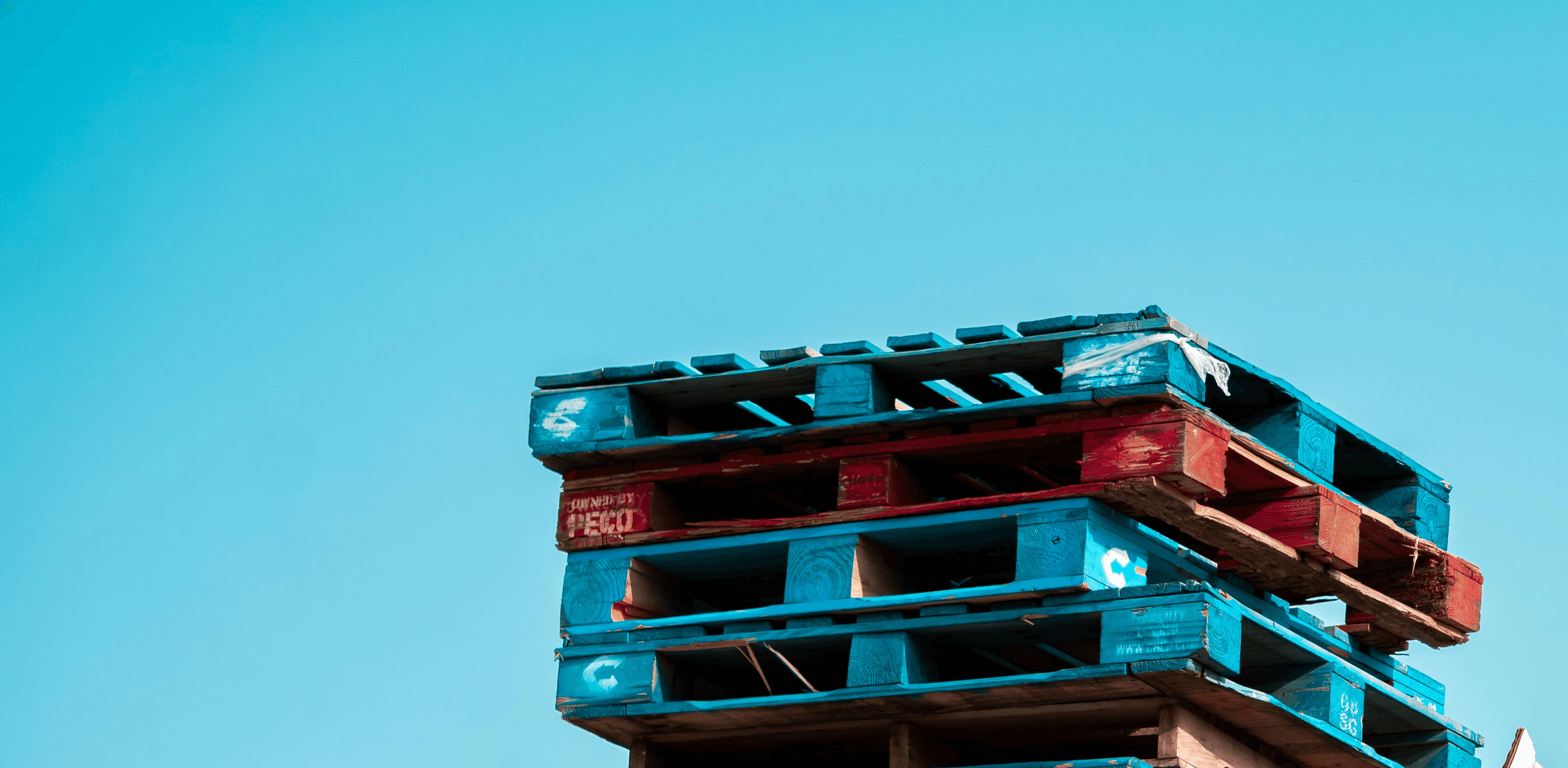 a pile of wooden pallets stacked on top of each other