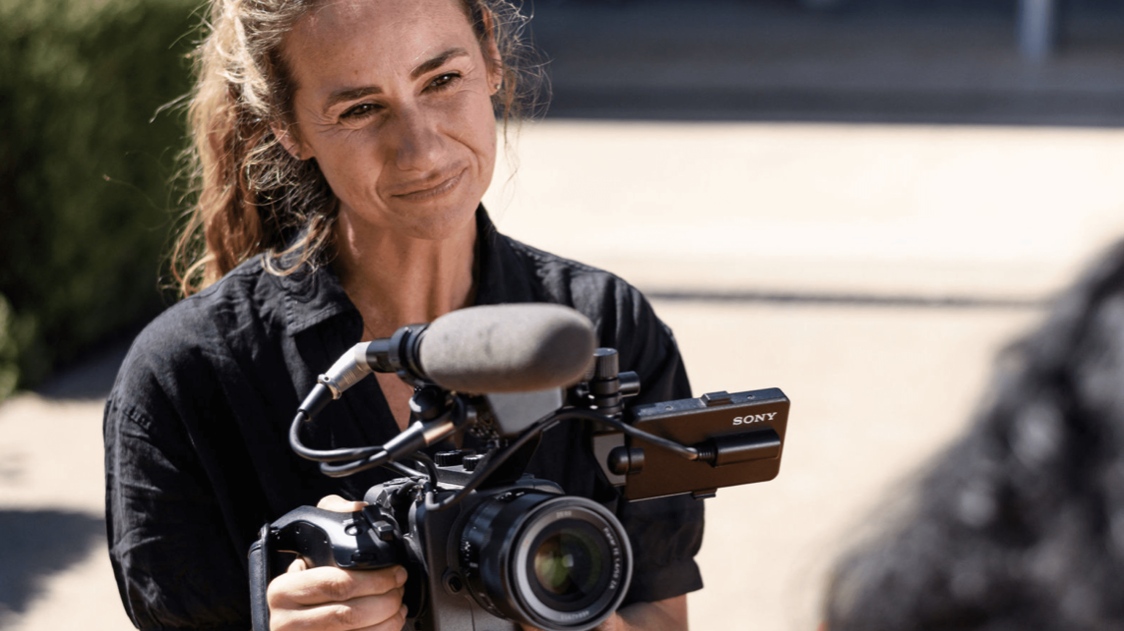 Photo of woman holding video camera