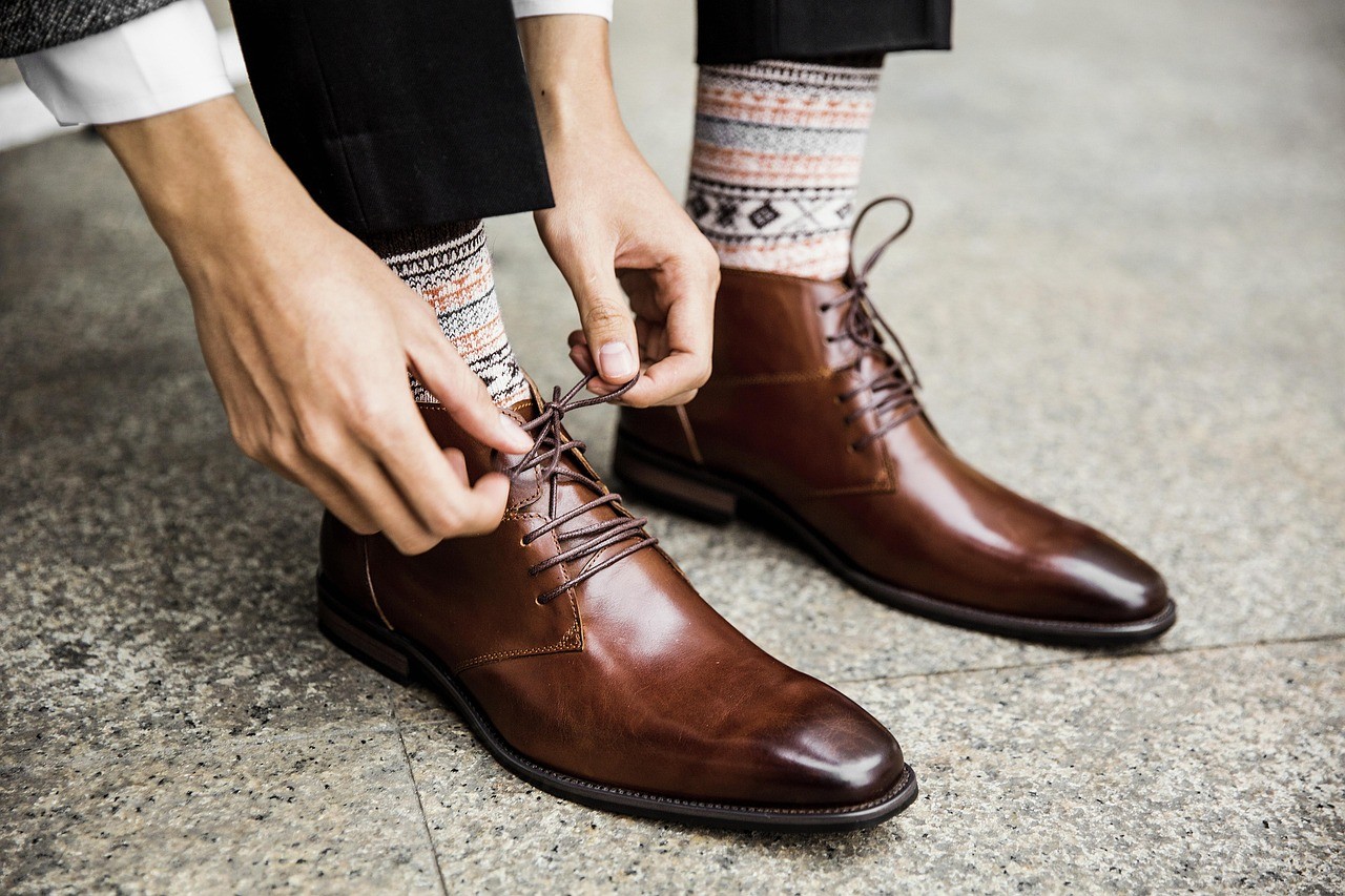 brown leather shoes on blue textile
