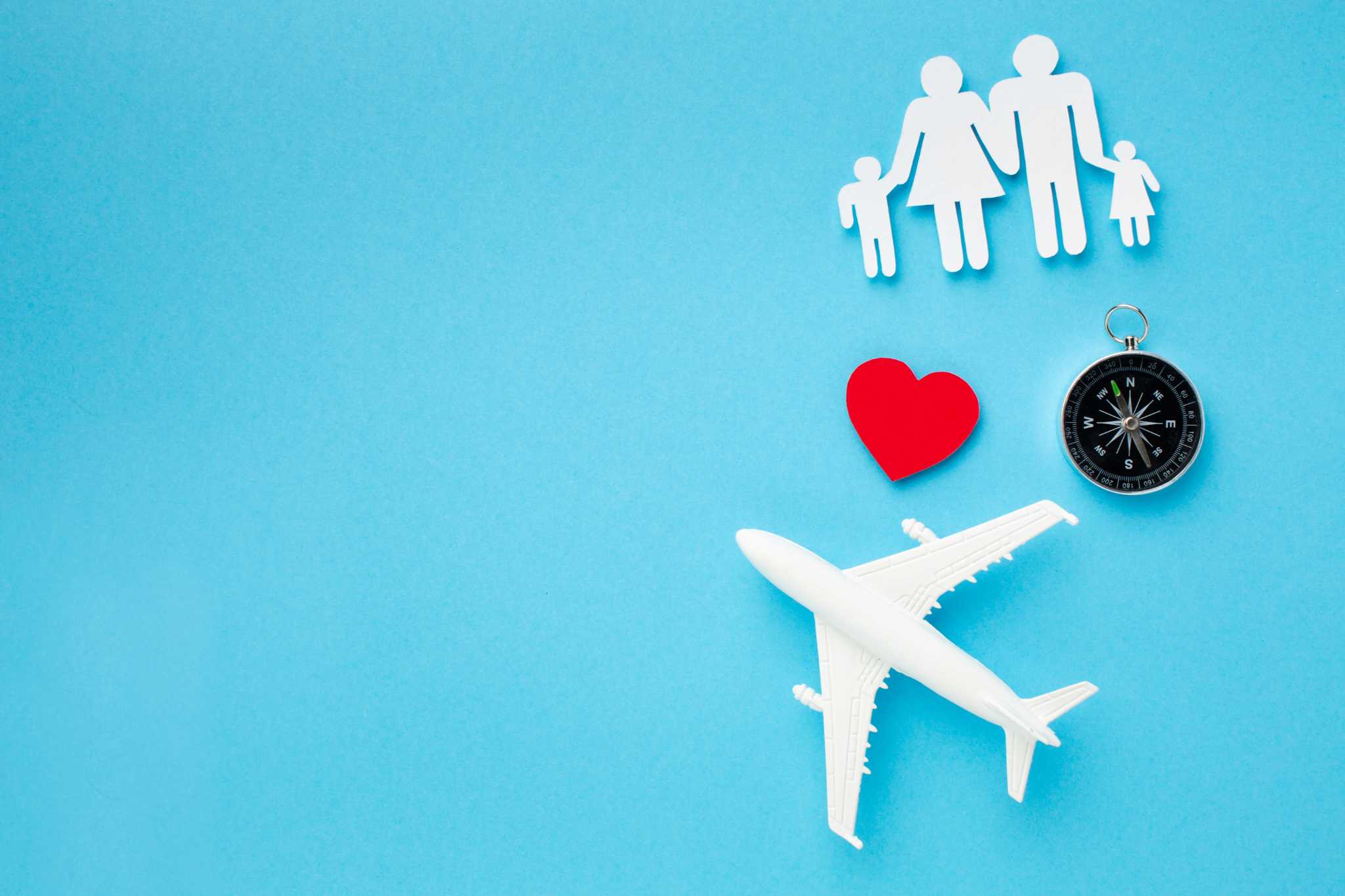 Landscape with a vineyard in rows leading to a building with a tower, rolling hills in the distance.