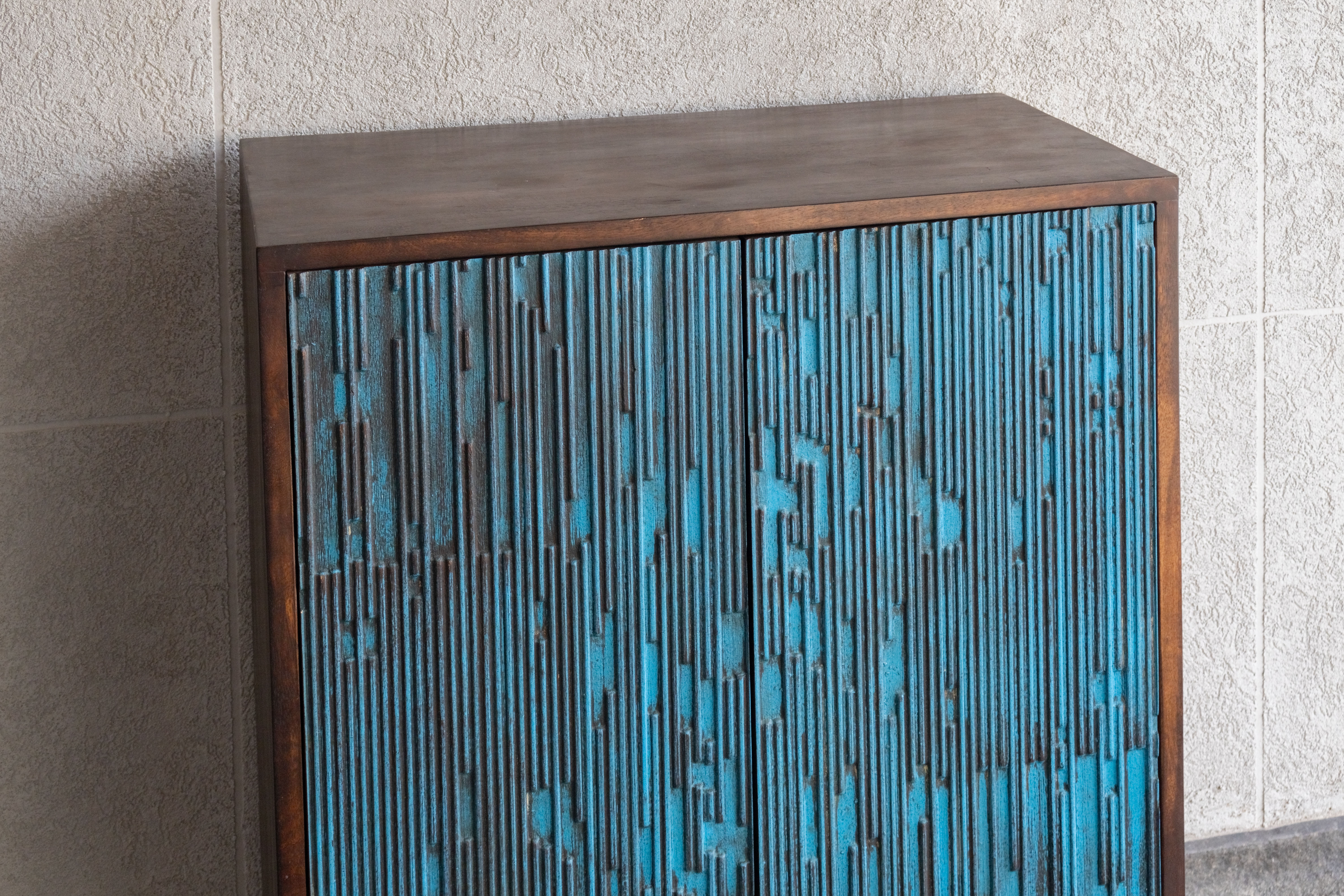 West India International Elysian collection made with deep blue tone of wood and chrome finished elements