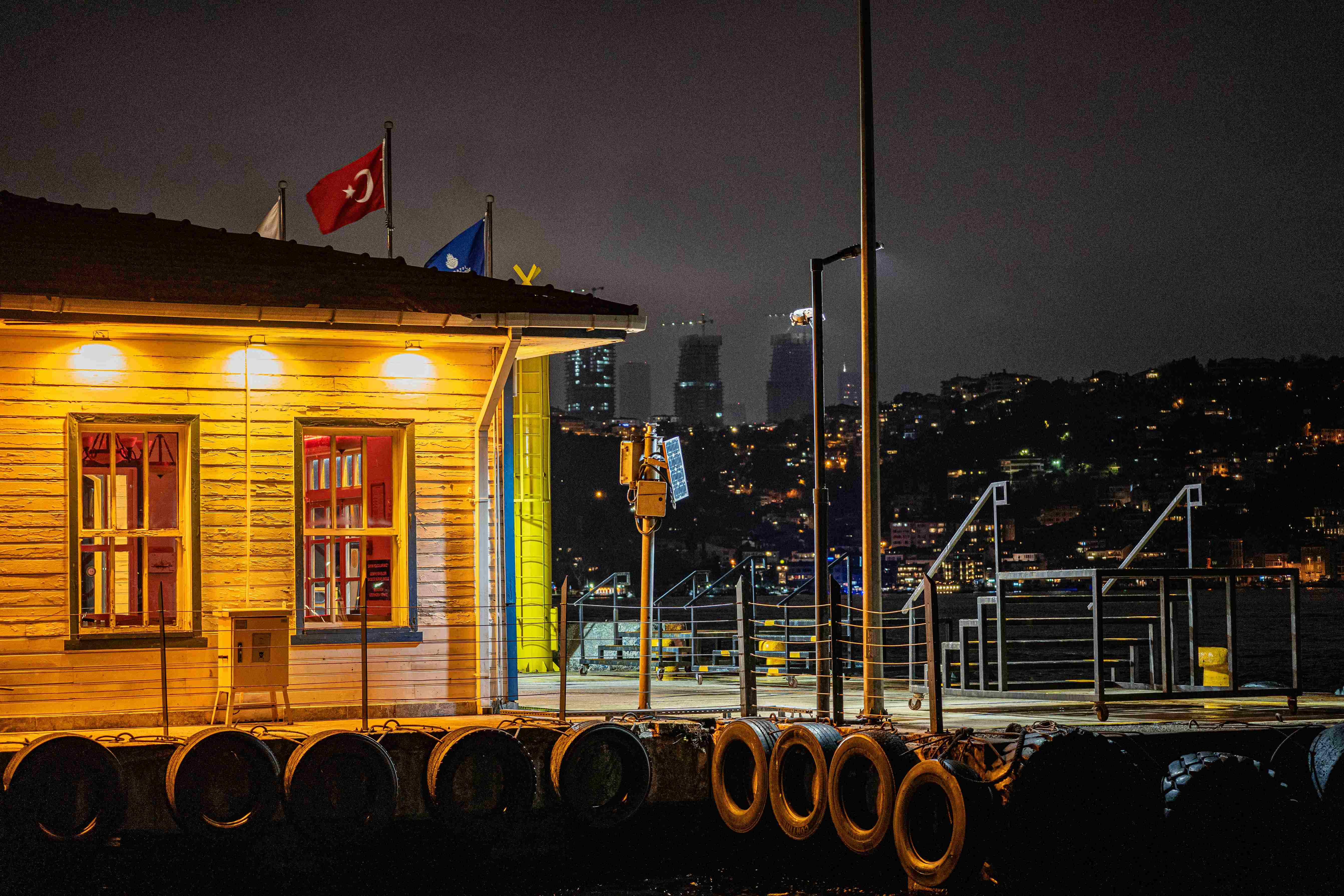 A marina dock with mooring structures and equipment at night, representing operational conditions and potential disputes related to yacht charter and berth usage