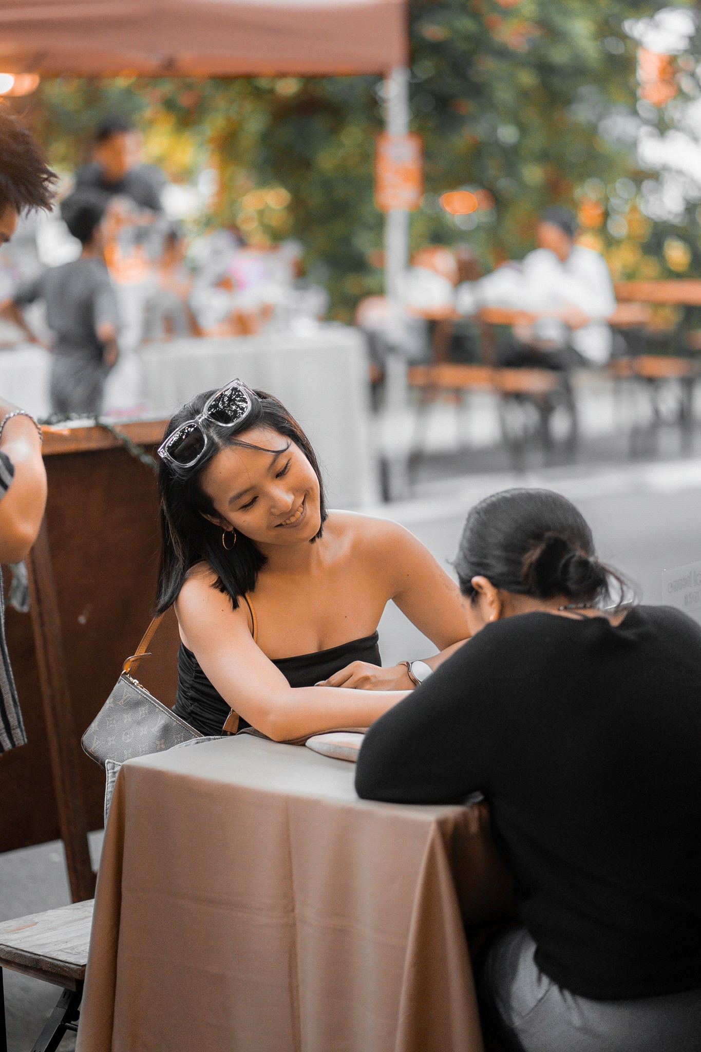 Henna artist applying henna on a customer at a pop-up event in Singapore.