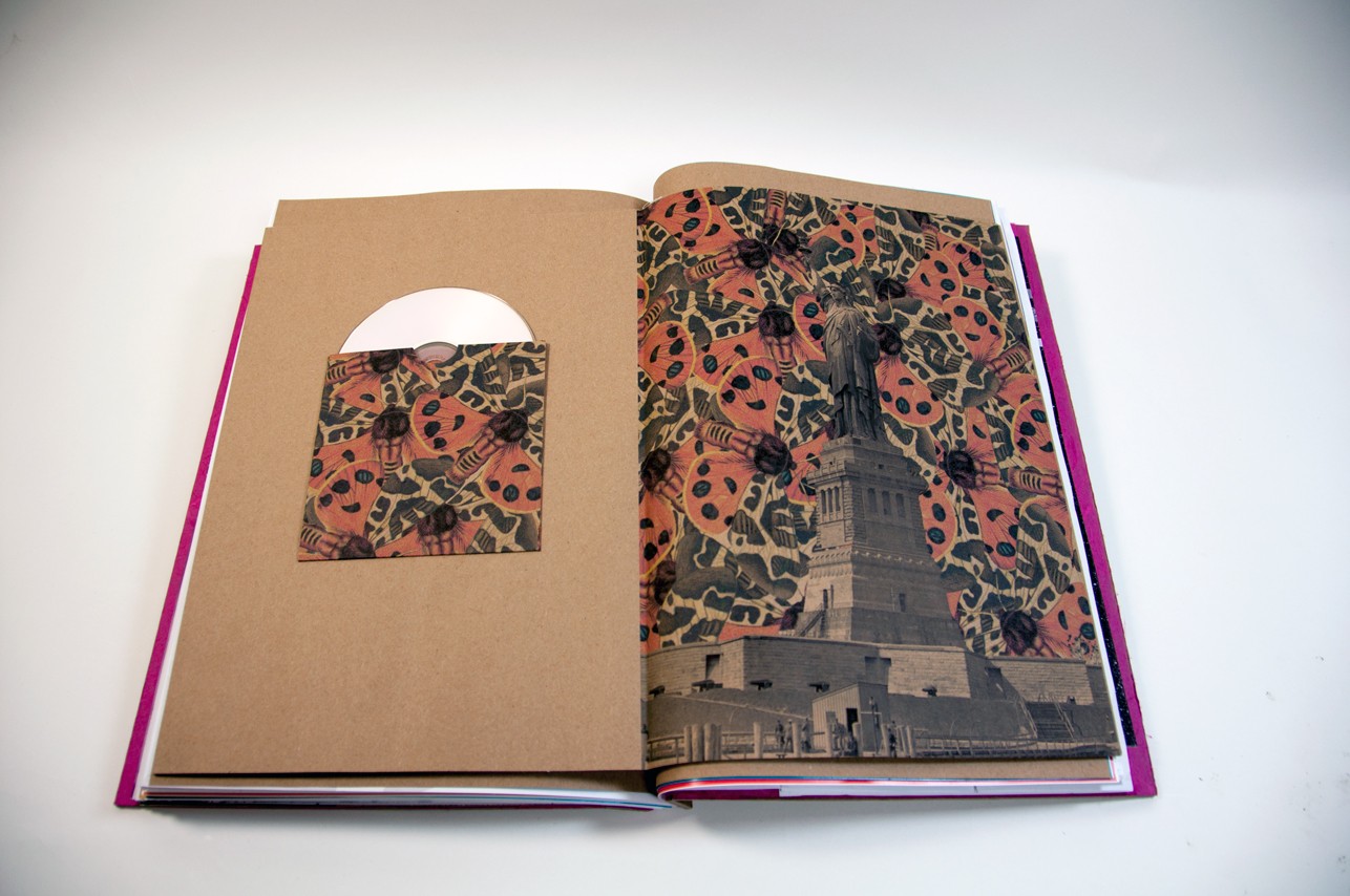 an opened book with an illustration of the liberty statue