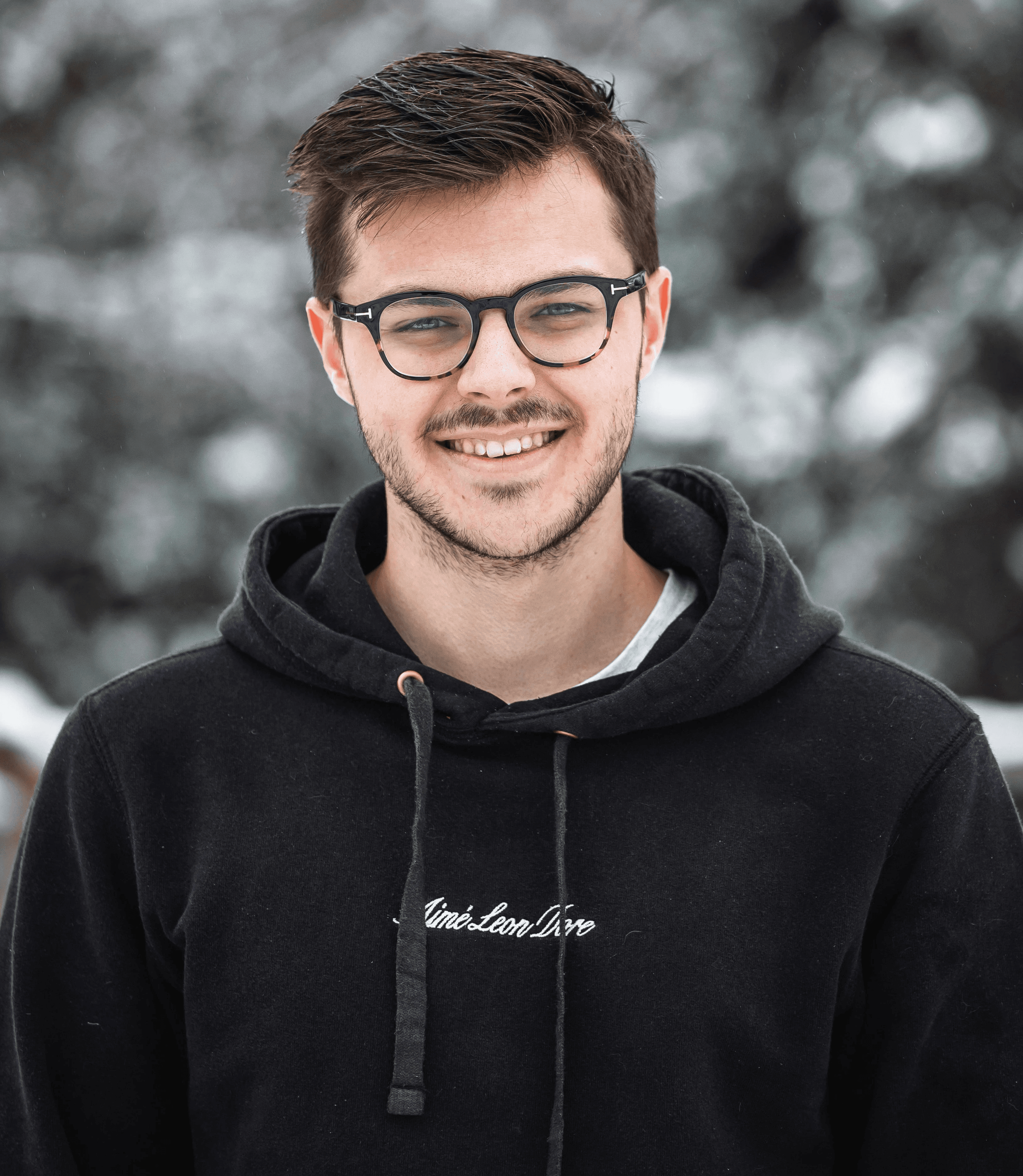man in black hoodie wearing black framed eyeglasses